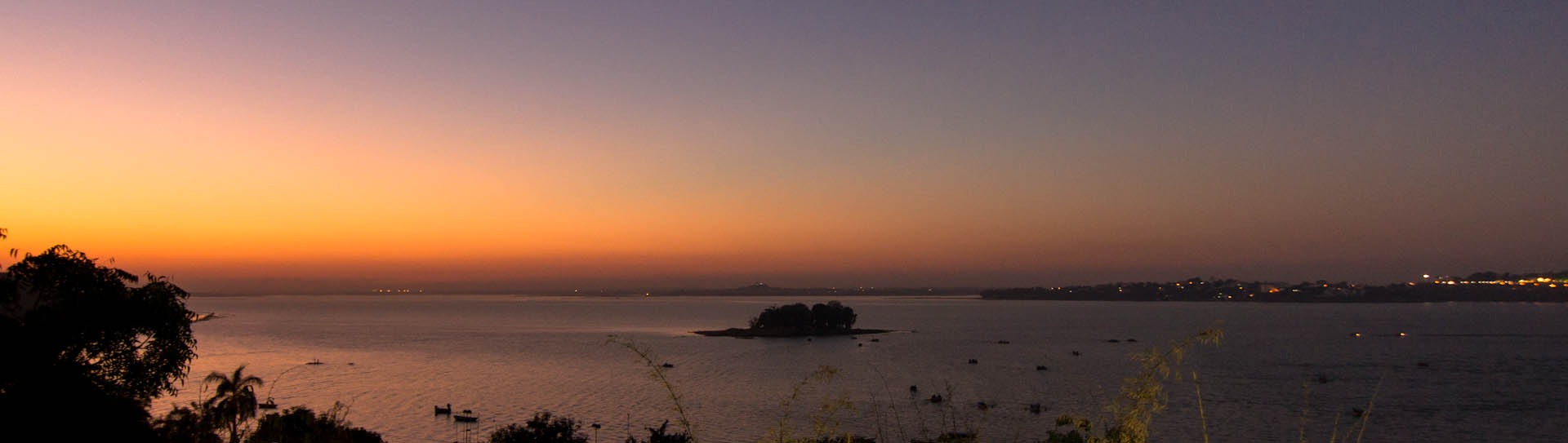 the sun is setting over a body of water