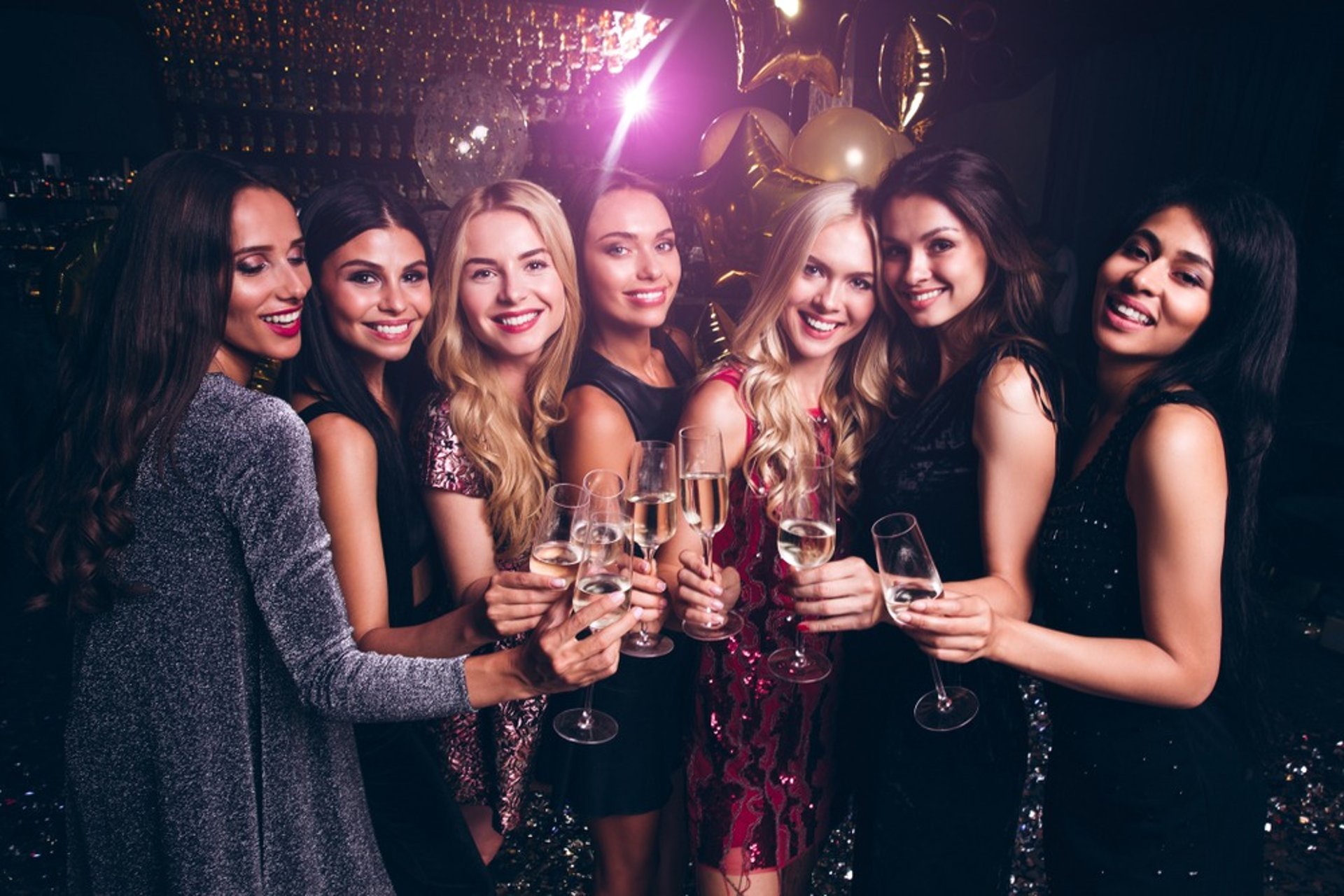 VIP group of women toasting champagne during a private club crawl in Las Vegas nightlife.