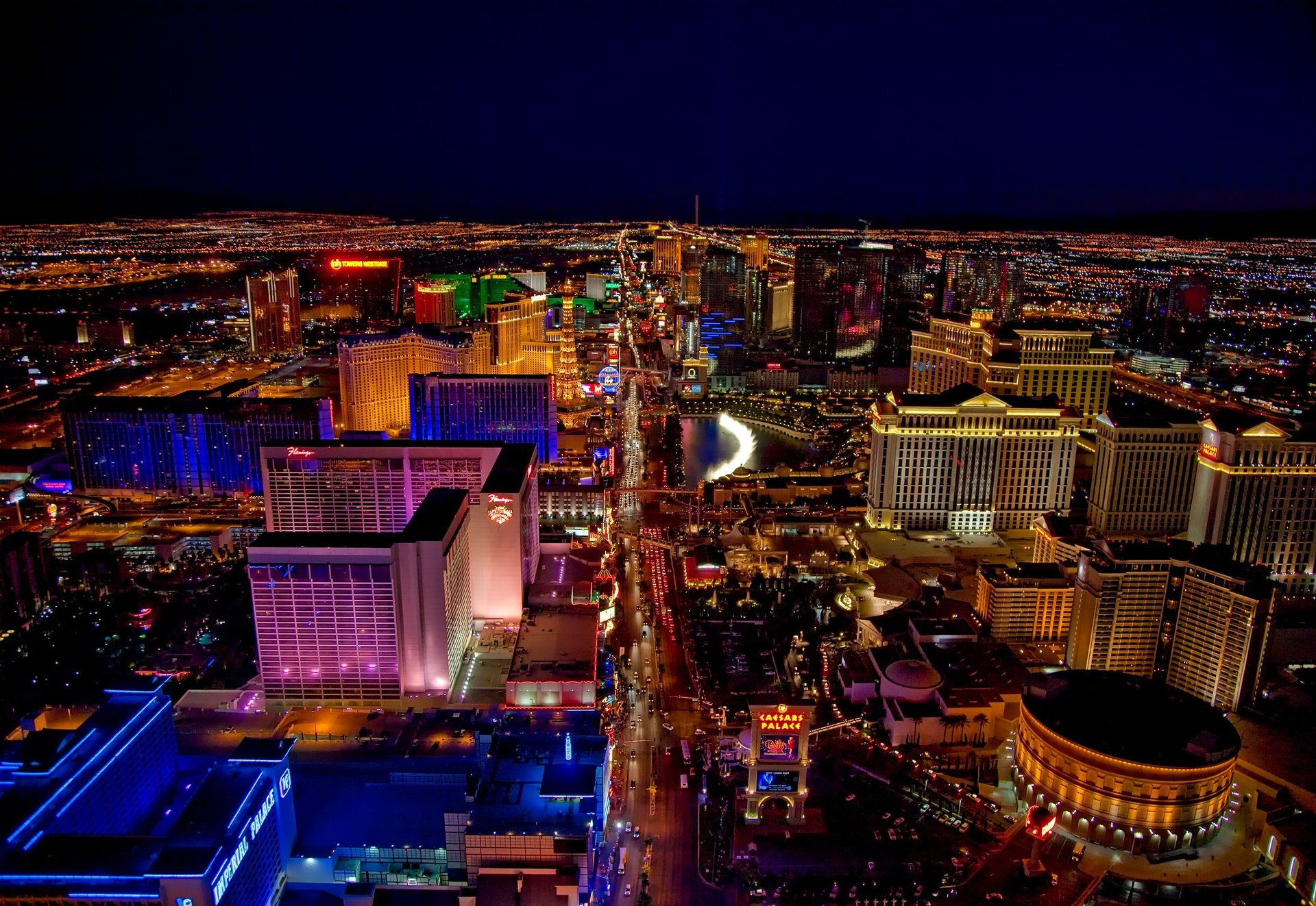 A breathtaking aerial view of the Las Vegas Strip at night, featuring brightly lit hotels and casinos