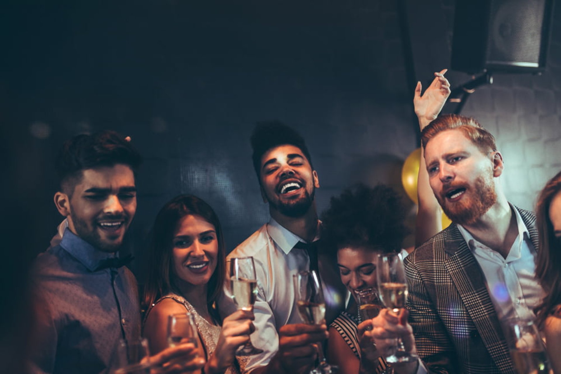Group of friends partying with champagne during a hip hop club crawl and party bus tour in Las Vegas