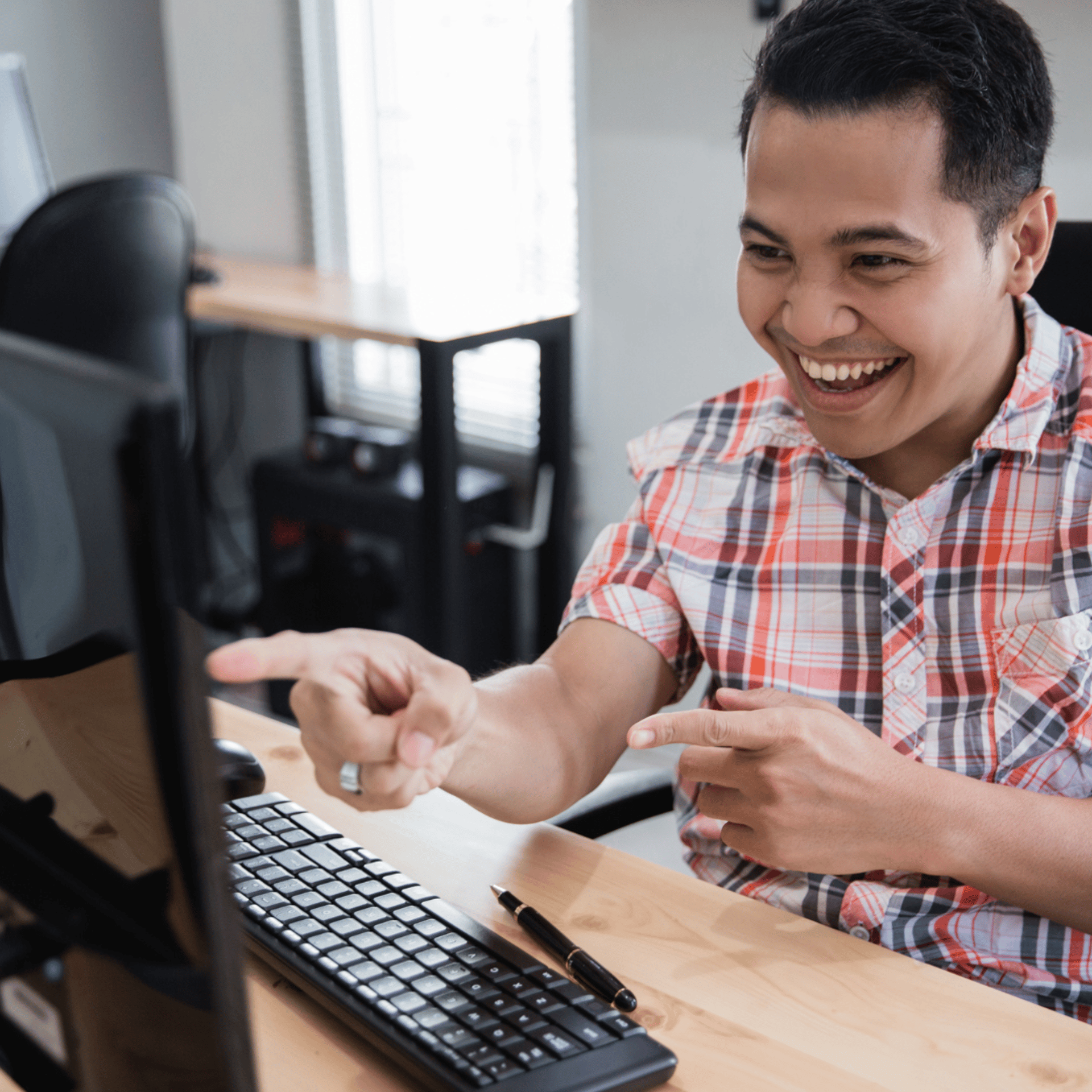 man operating laptop on top of table