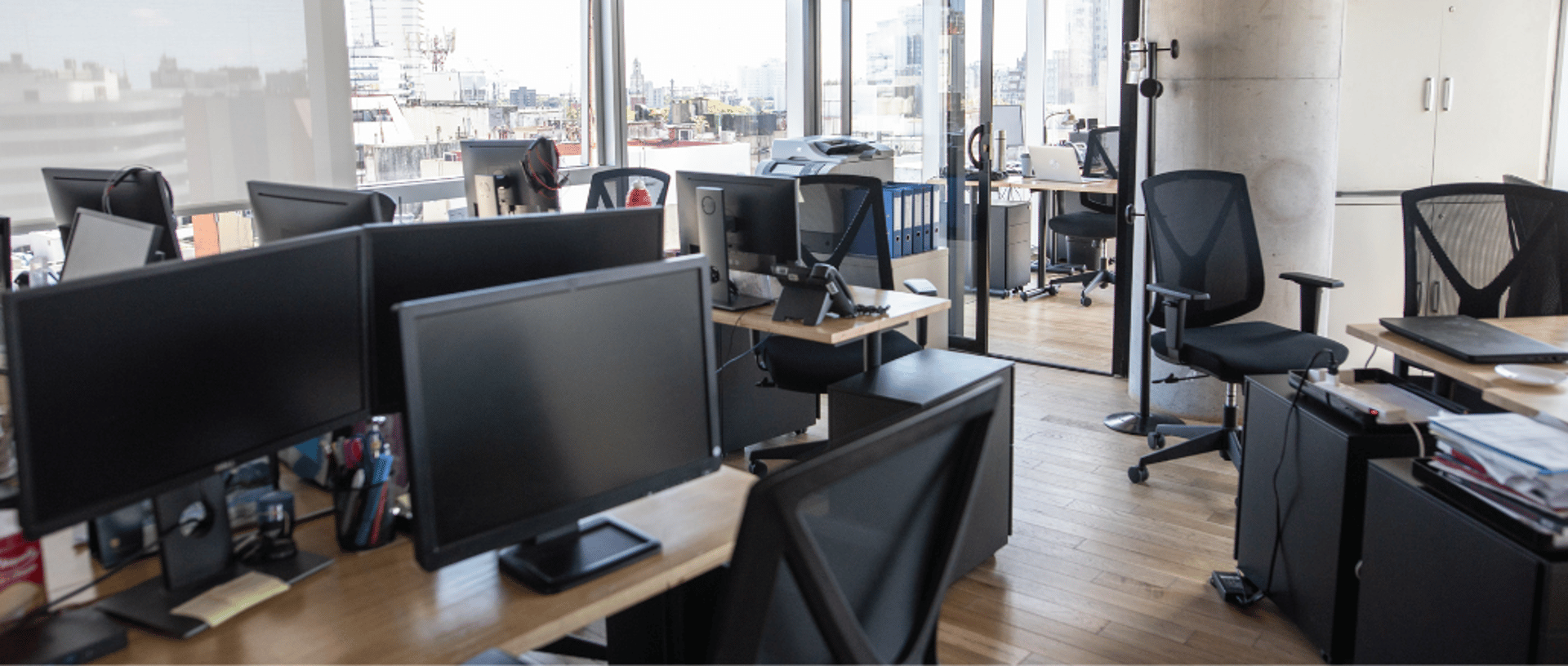 empty black rolling chairs at cubicles