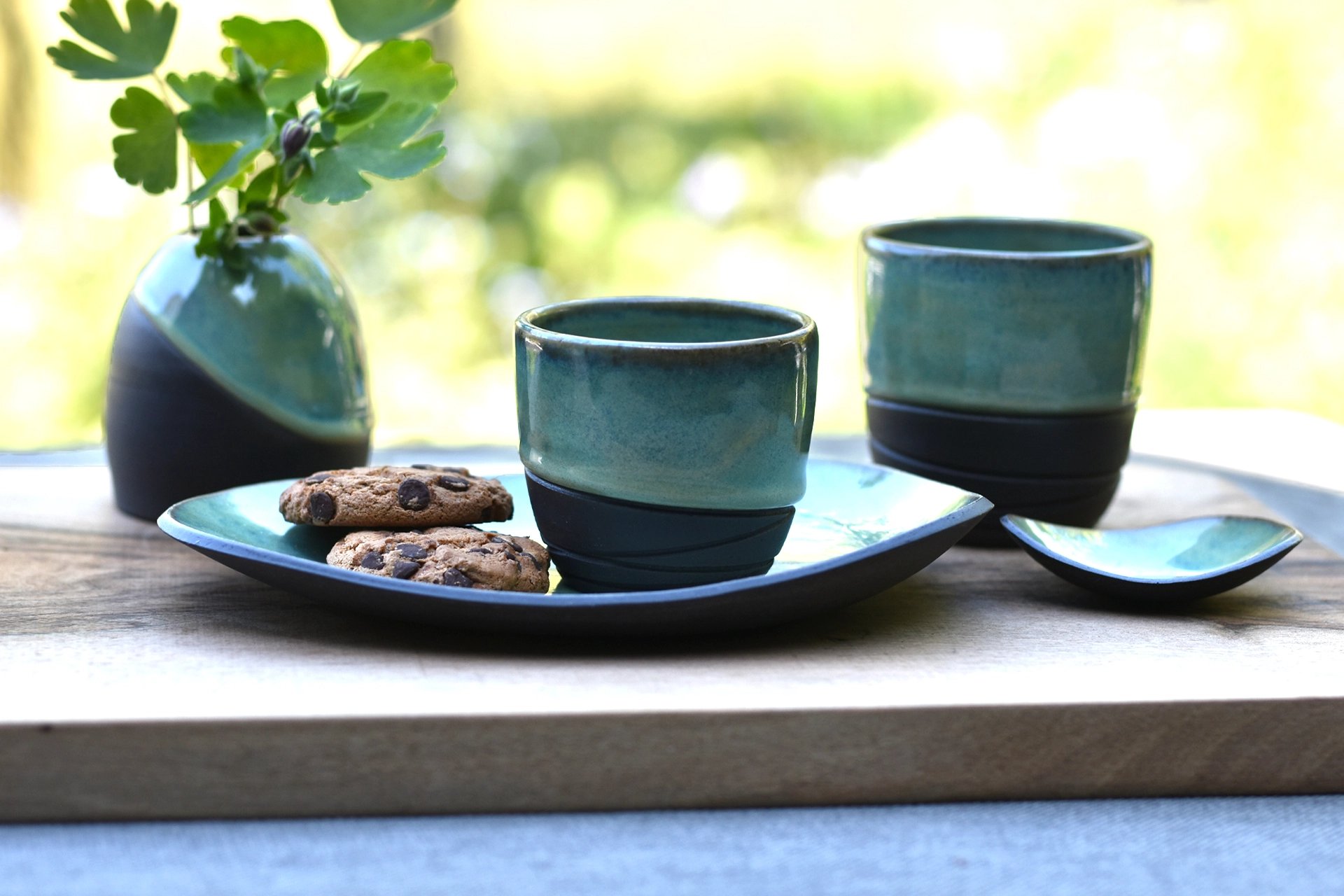 Handgemaakte keramieken koffiekopjes met schoteltje zwarte steengoed klei met sage groene glazuur