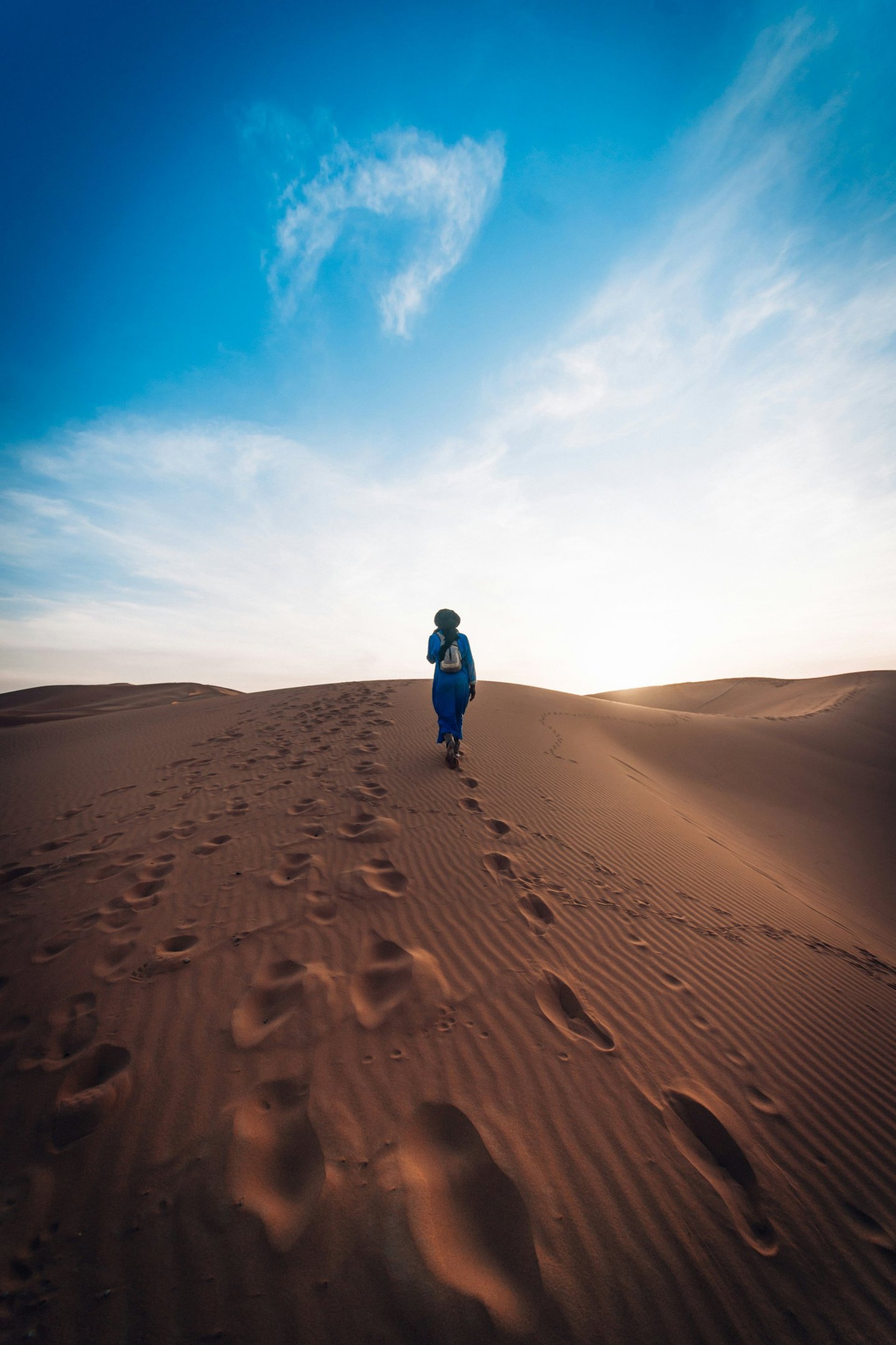 white clouds over brown mountains