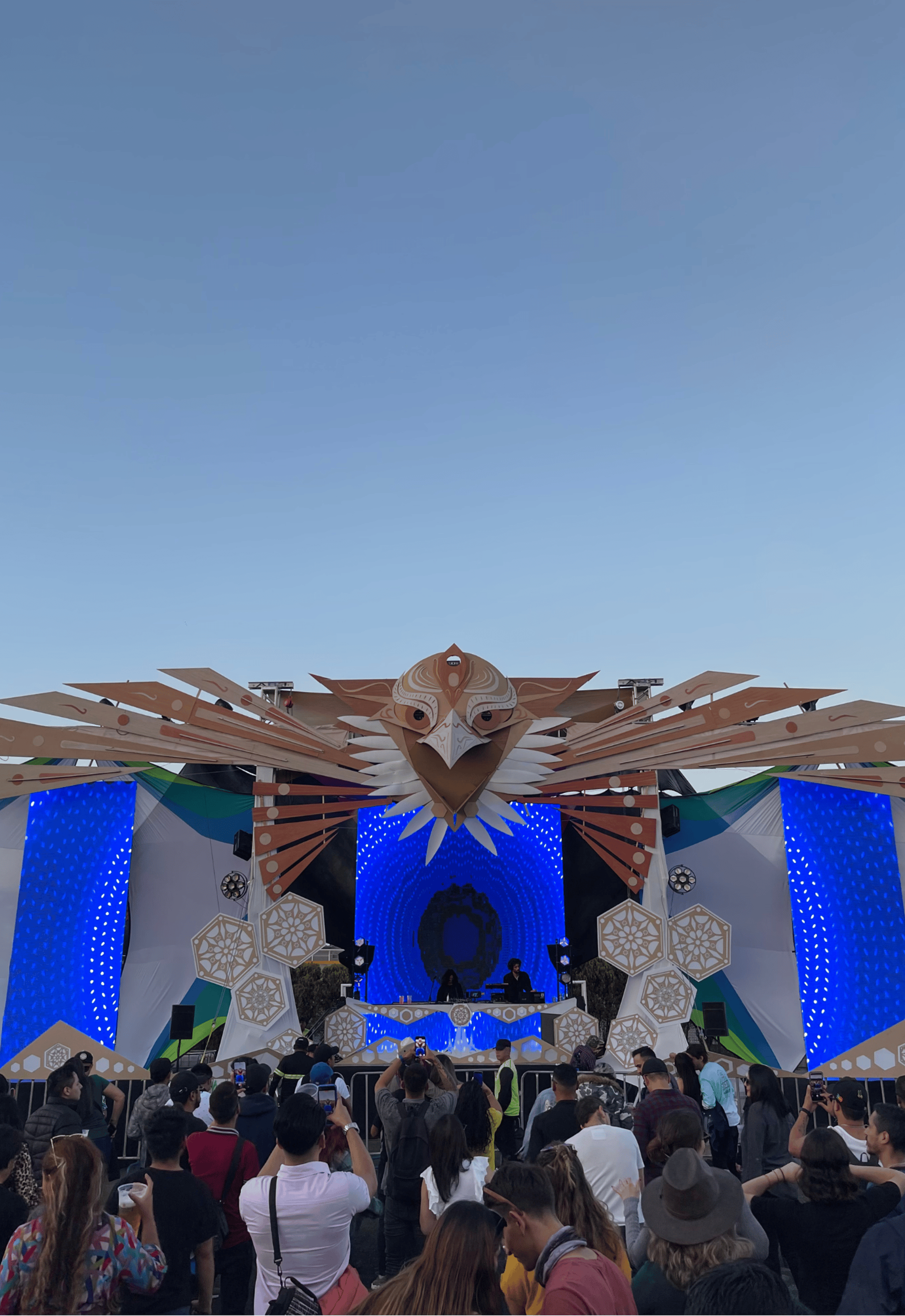 an abstract photo of a curved building with a blue sky in the background