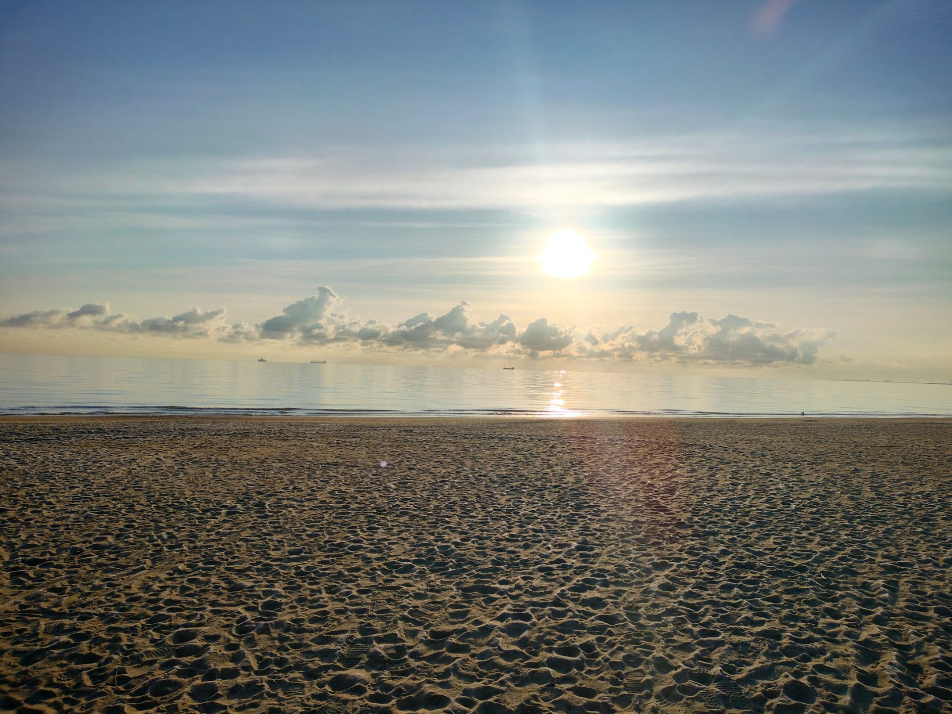 an abstract photo of a curved building with a blue sky in the background
