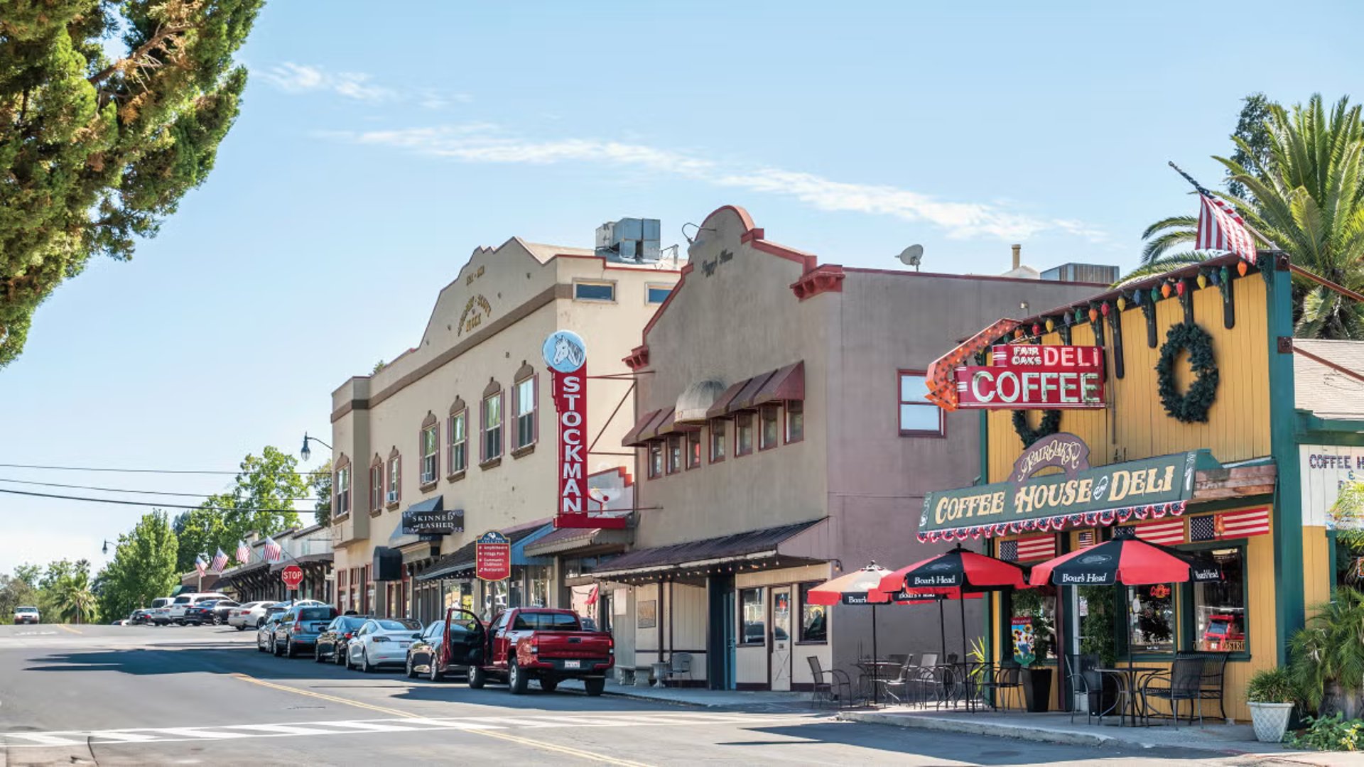 A serene river flows under a cloudy blue sky.