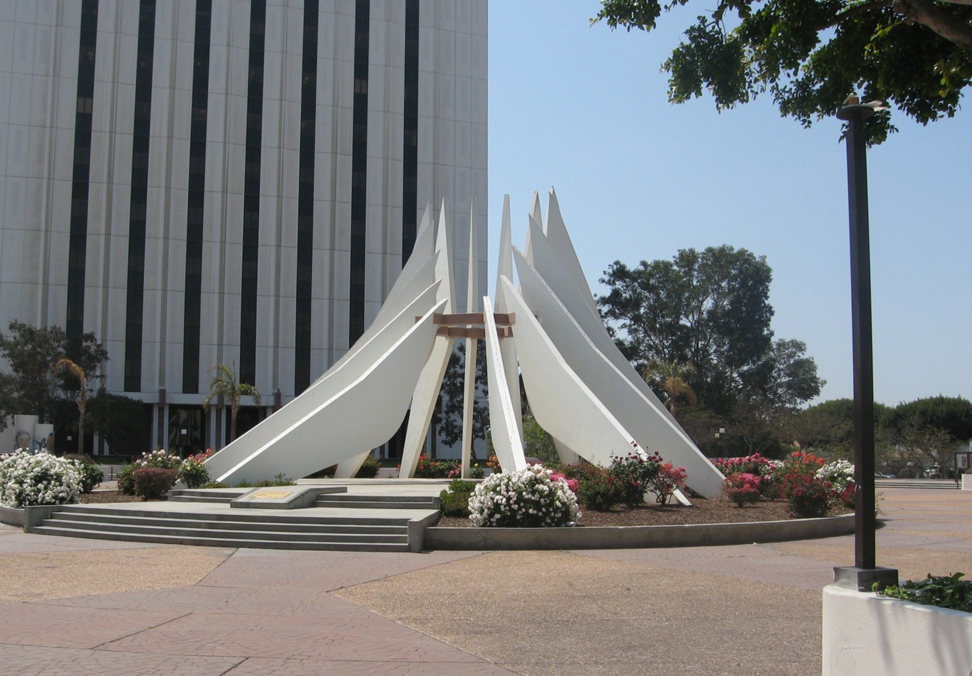 an abstract photo of a curved building with a blue sky in the background