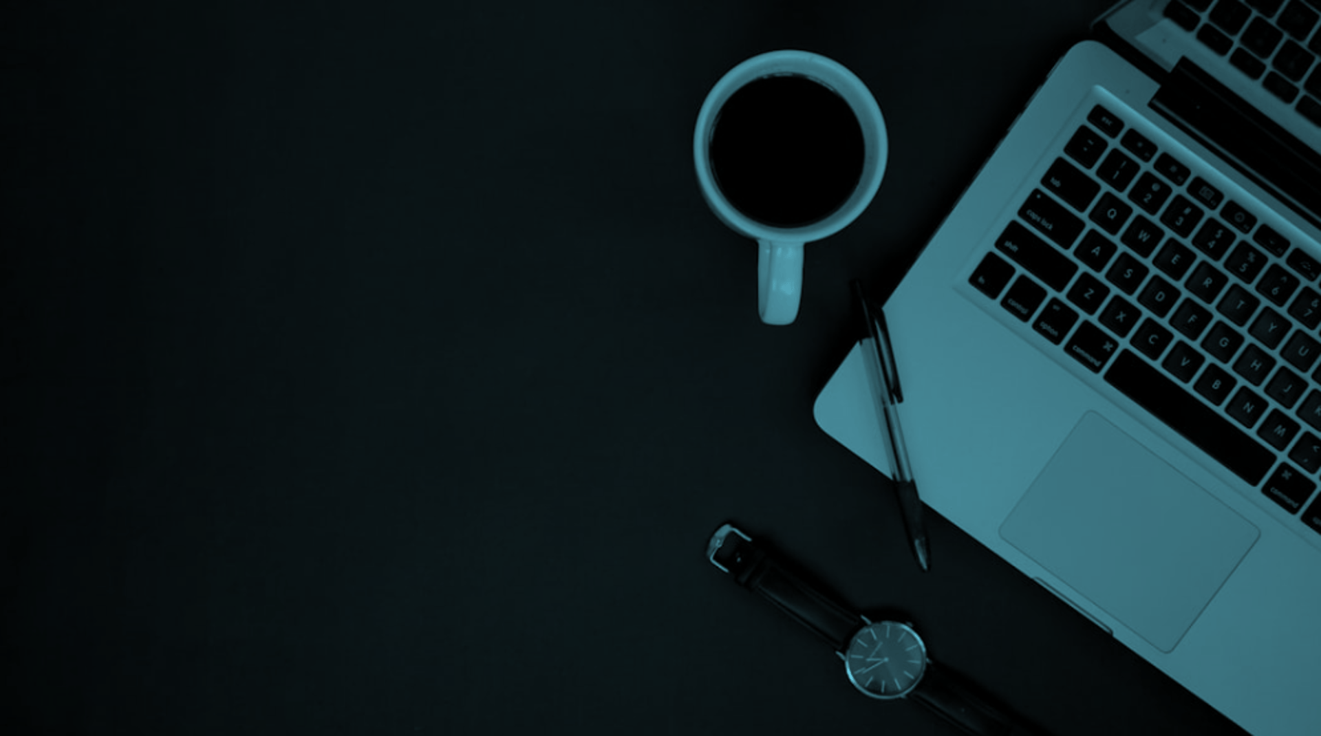 black laptop computer turned on beside black ceramic mug