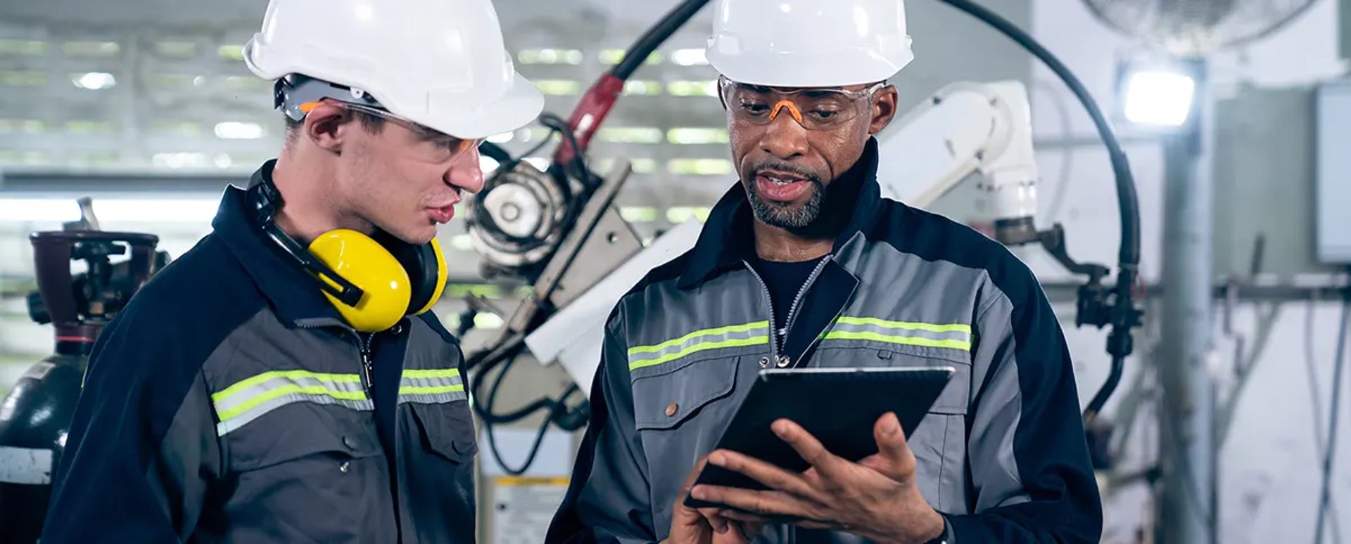 a man wearing a headset sitting in front of a computer