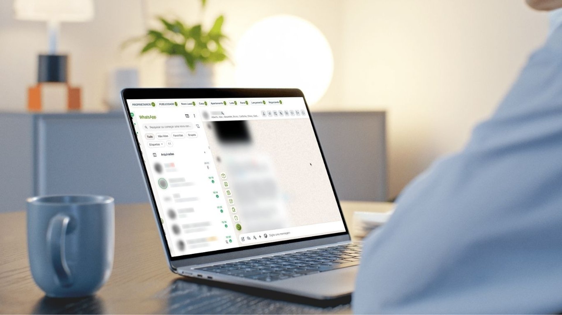 A MacBook with lines of code on its screen on a busy desk