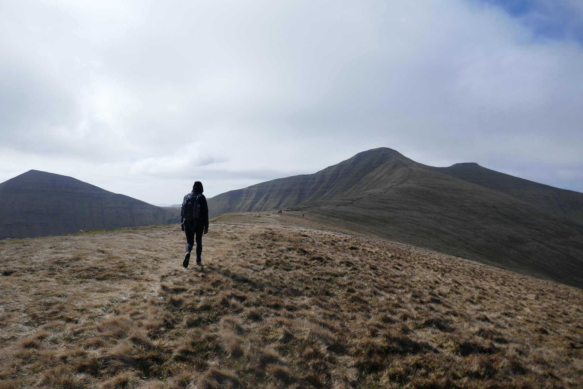 silhouette of man standing on cliff