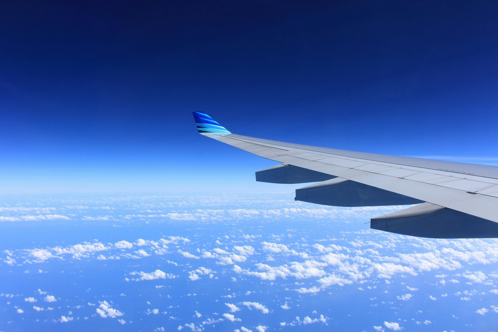 white and blue passenger plane on airport during daytime