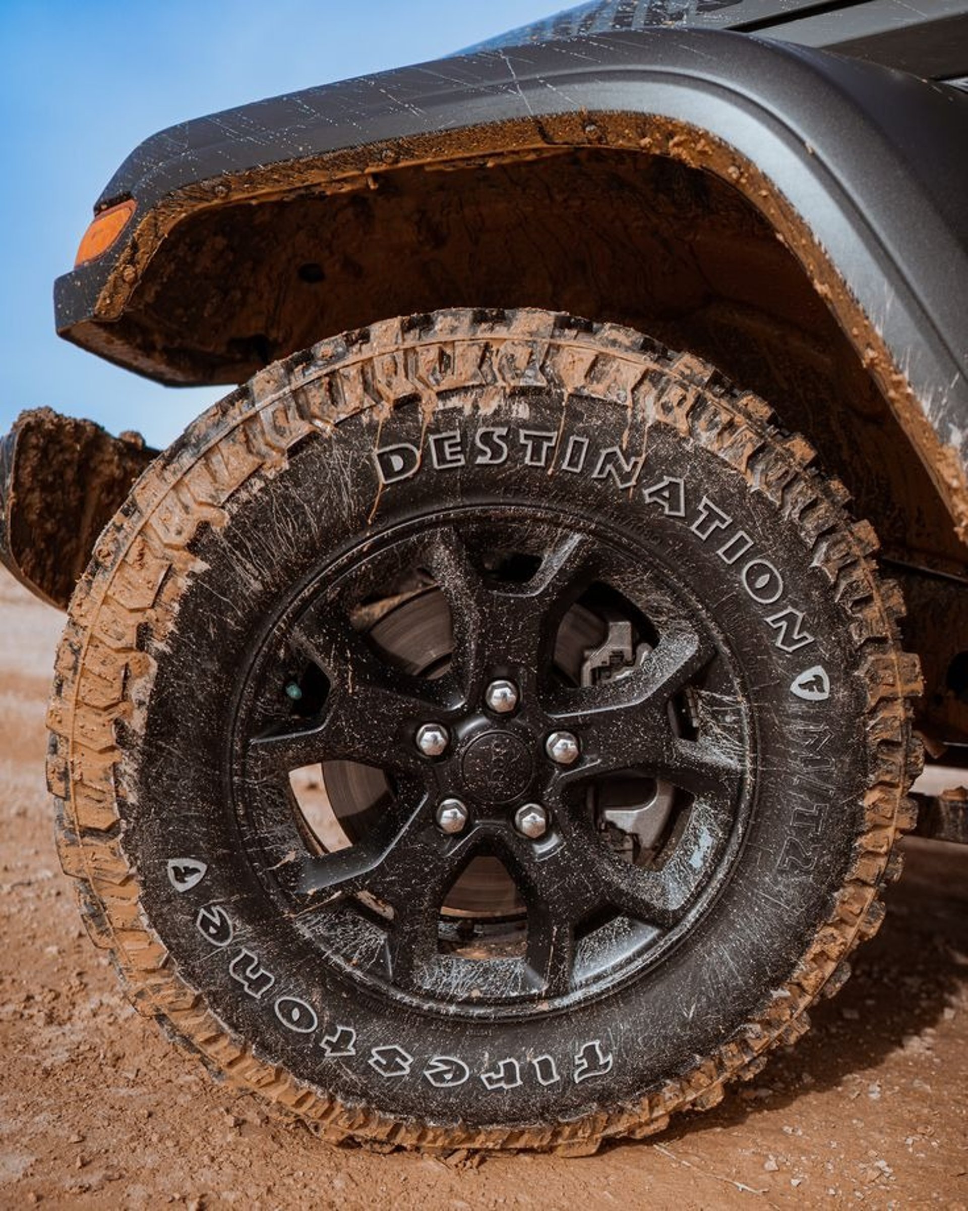 an abstract photo of a curved building with a blue sky in the background