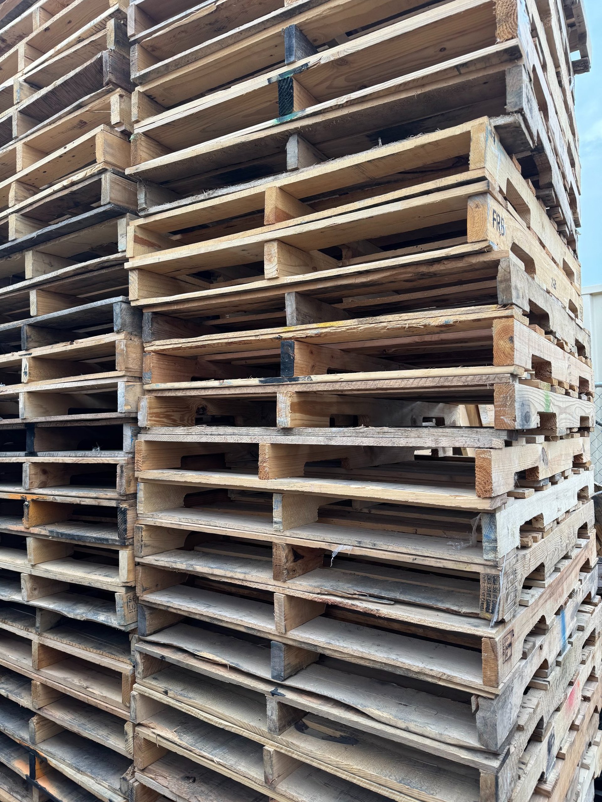 a pile of wooden pallets covered in snow