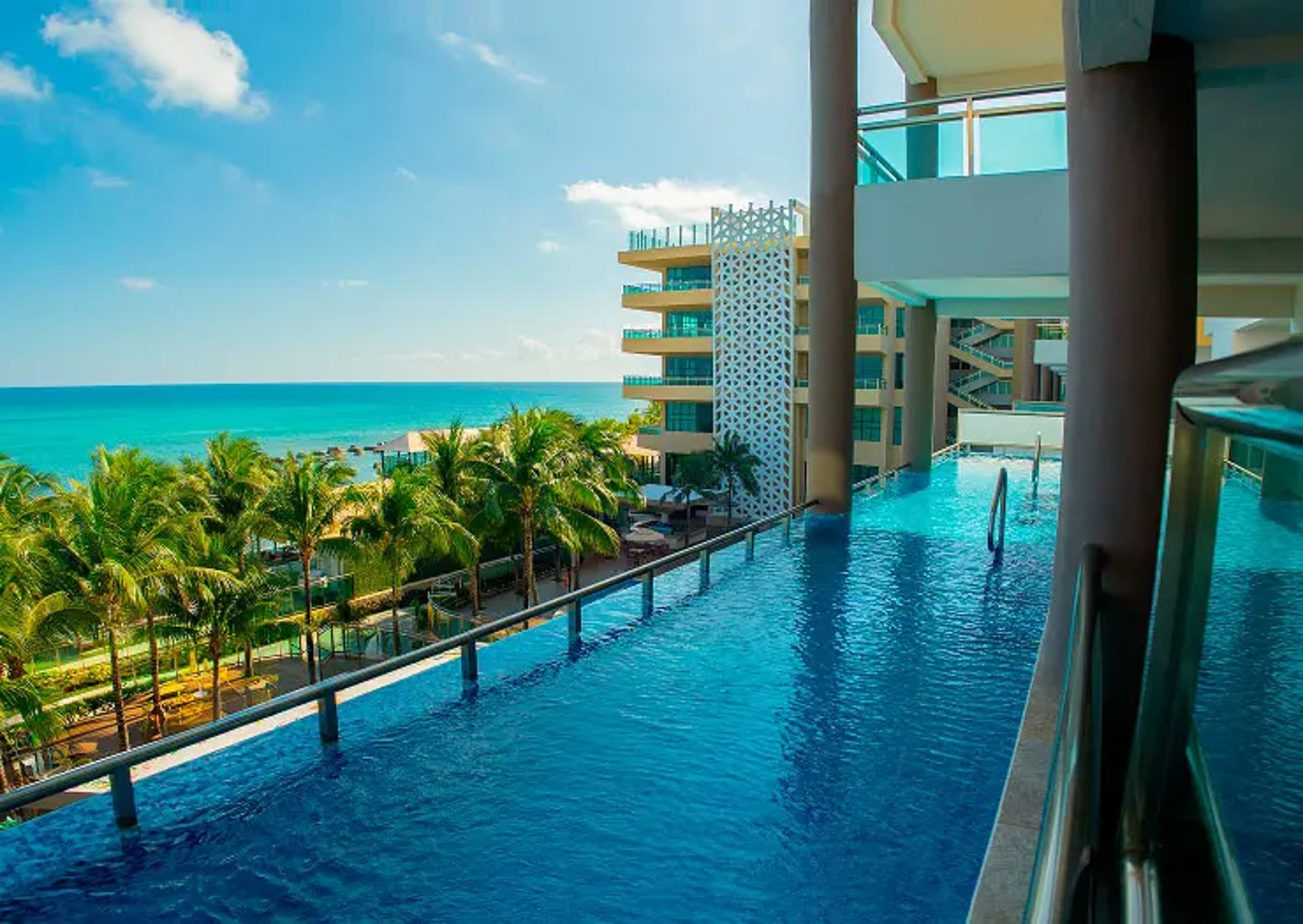 blue sea beside brown rocky mountain under blue sky during daytime