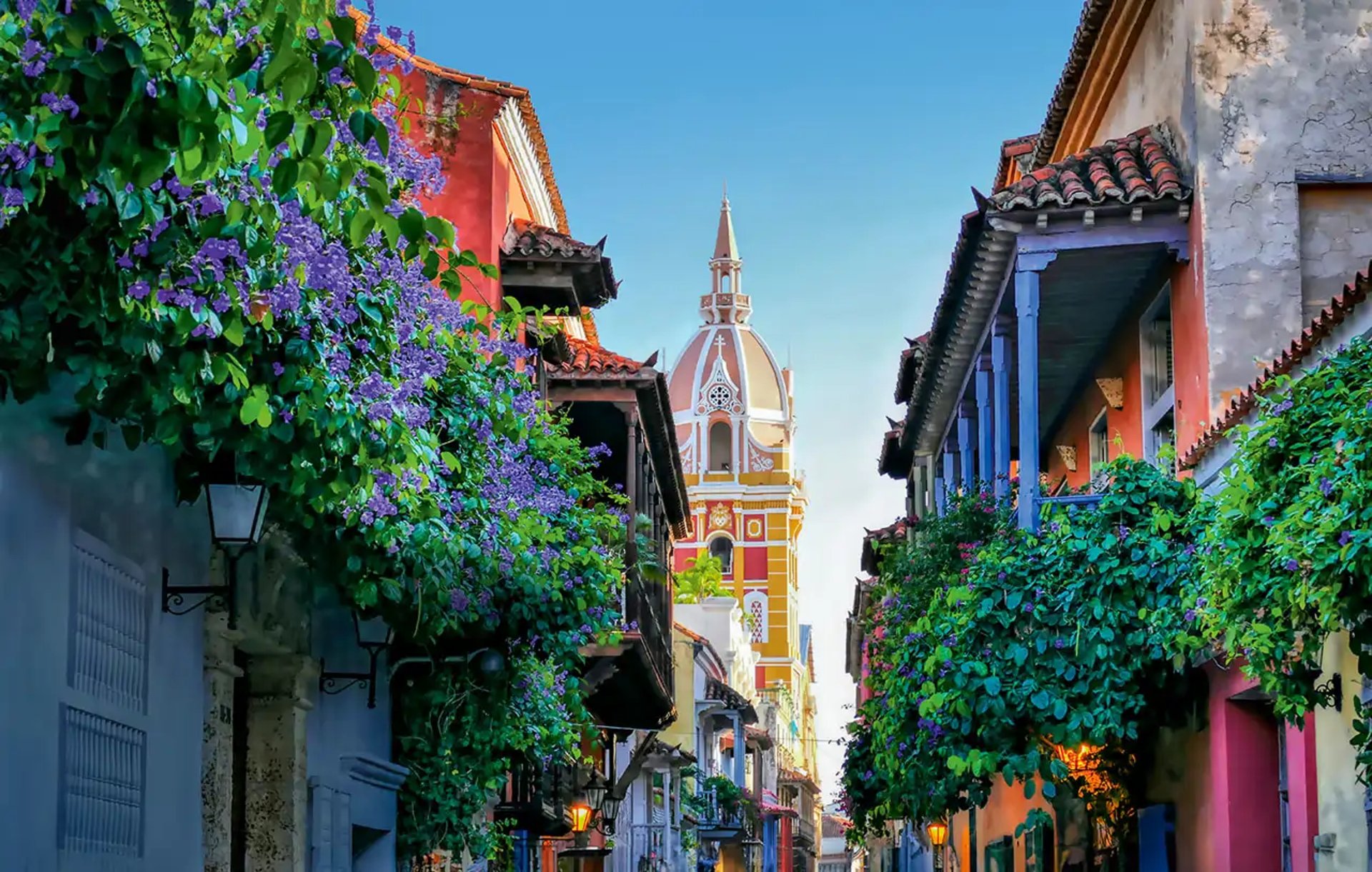 cars parked in front of green and white concrete building during daytime