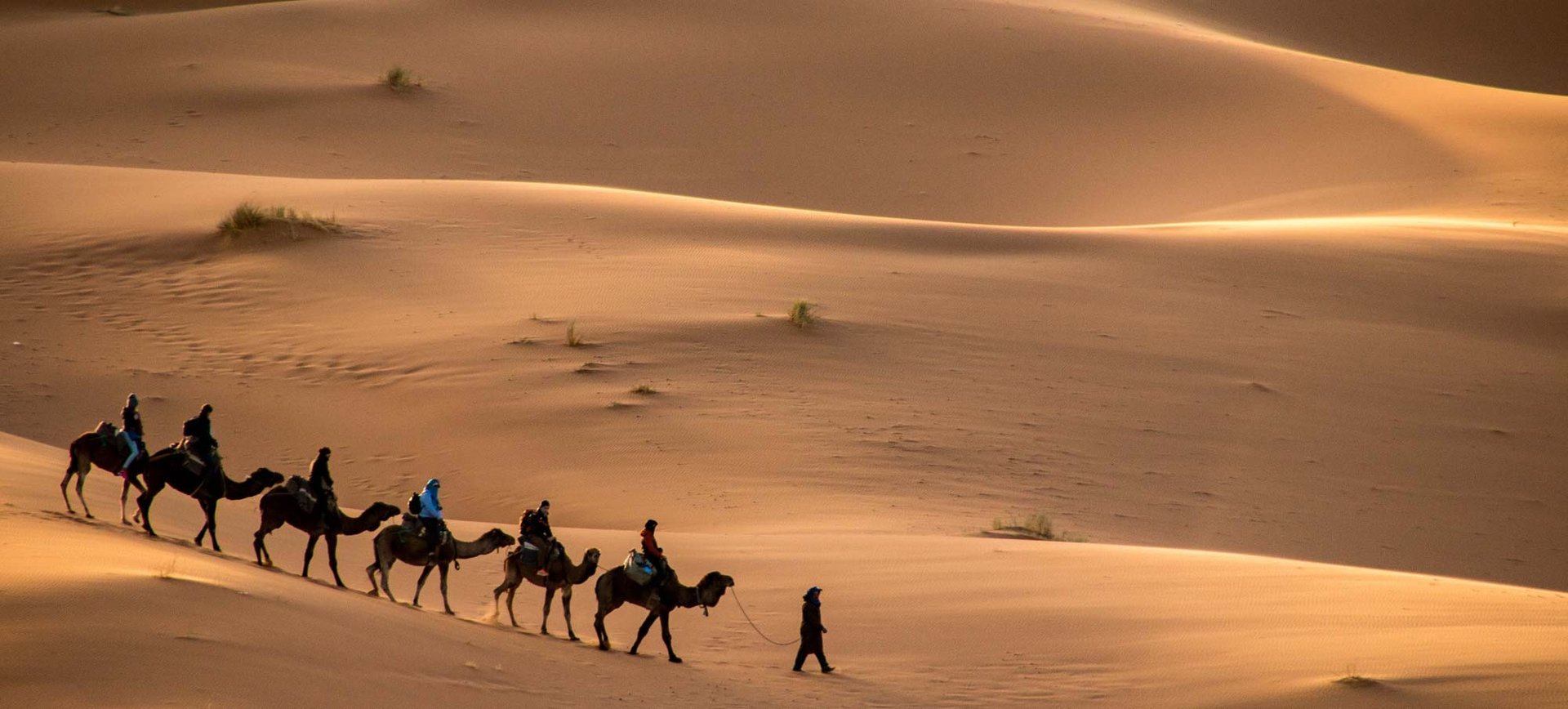 girl in blue shirt lying on white textile