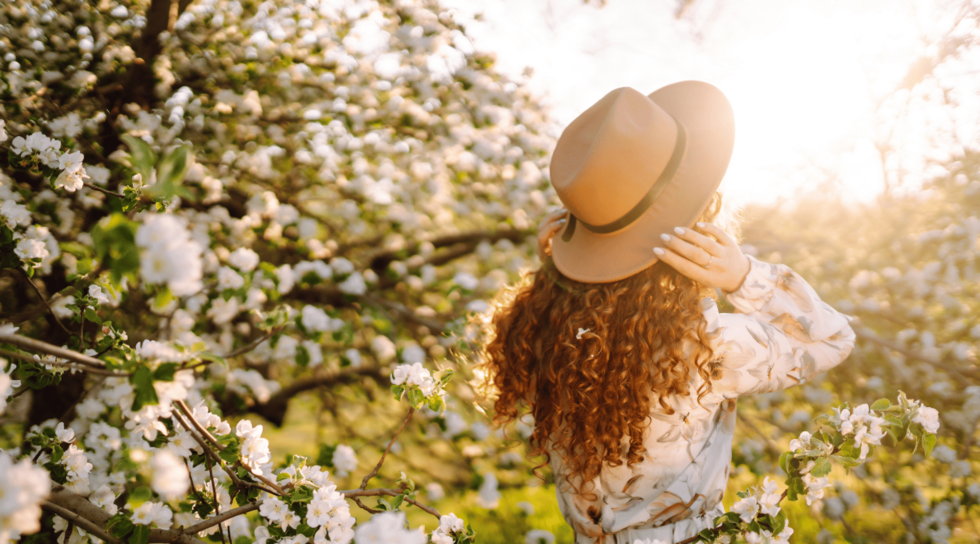 woman in black jacket holding her hair