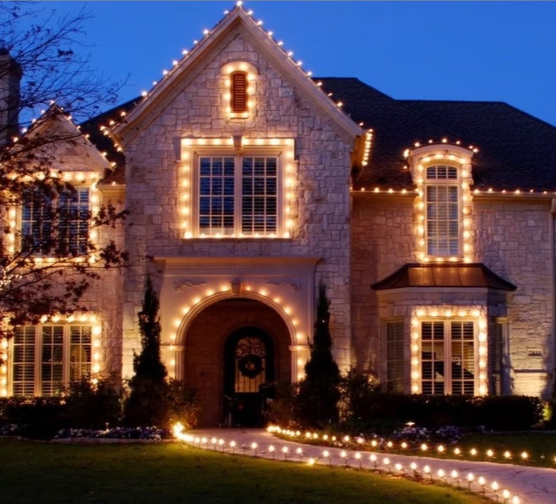 House adorned with lights at dusk.