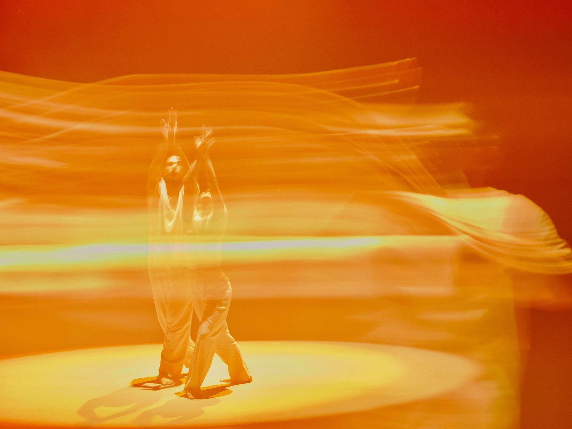 an abstract photo of a curved building with a blue sky in the background