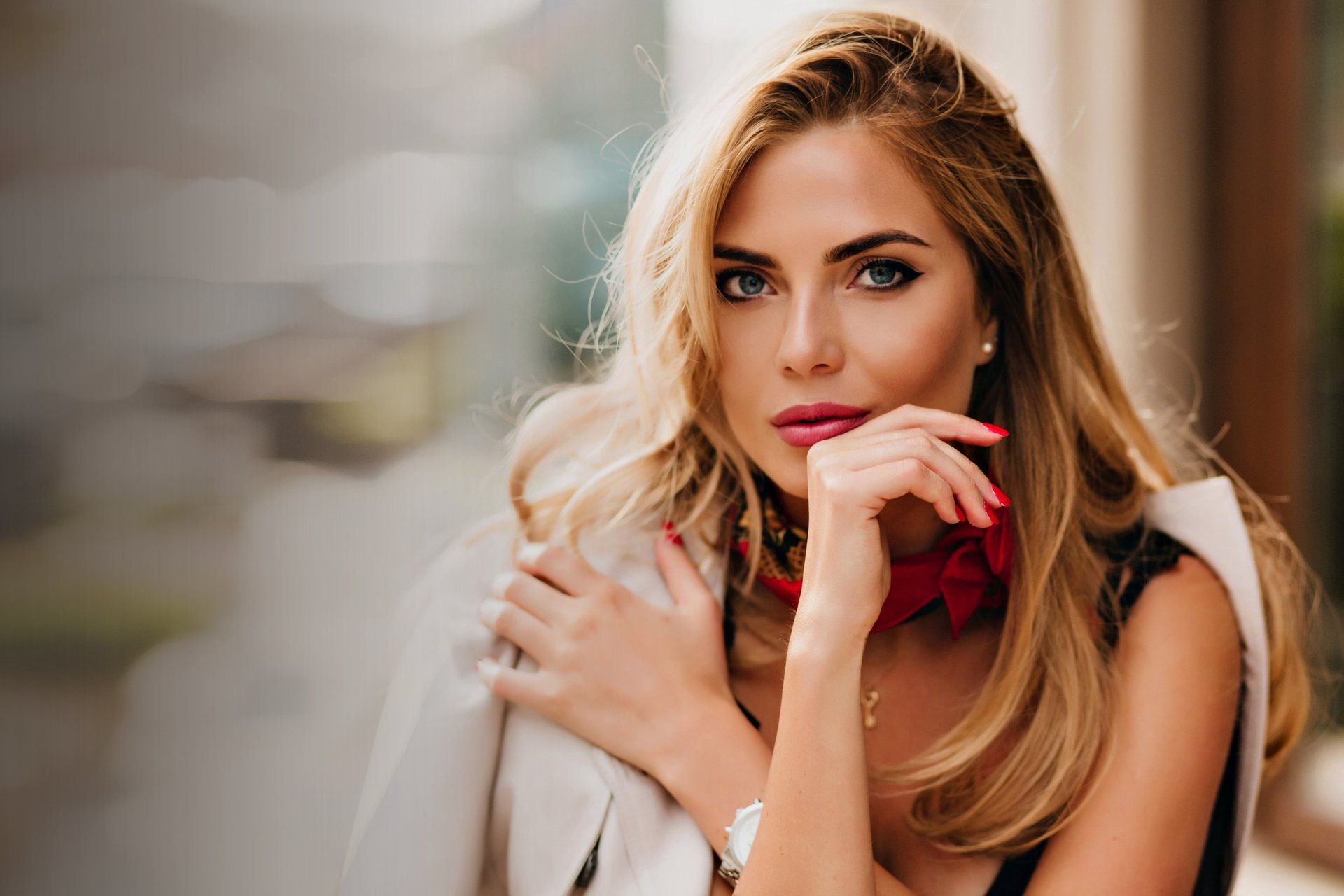 a woman laying on the ground with a peace sign in her hand