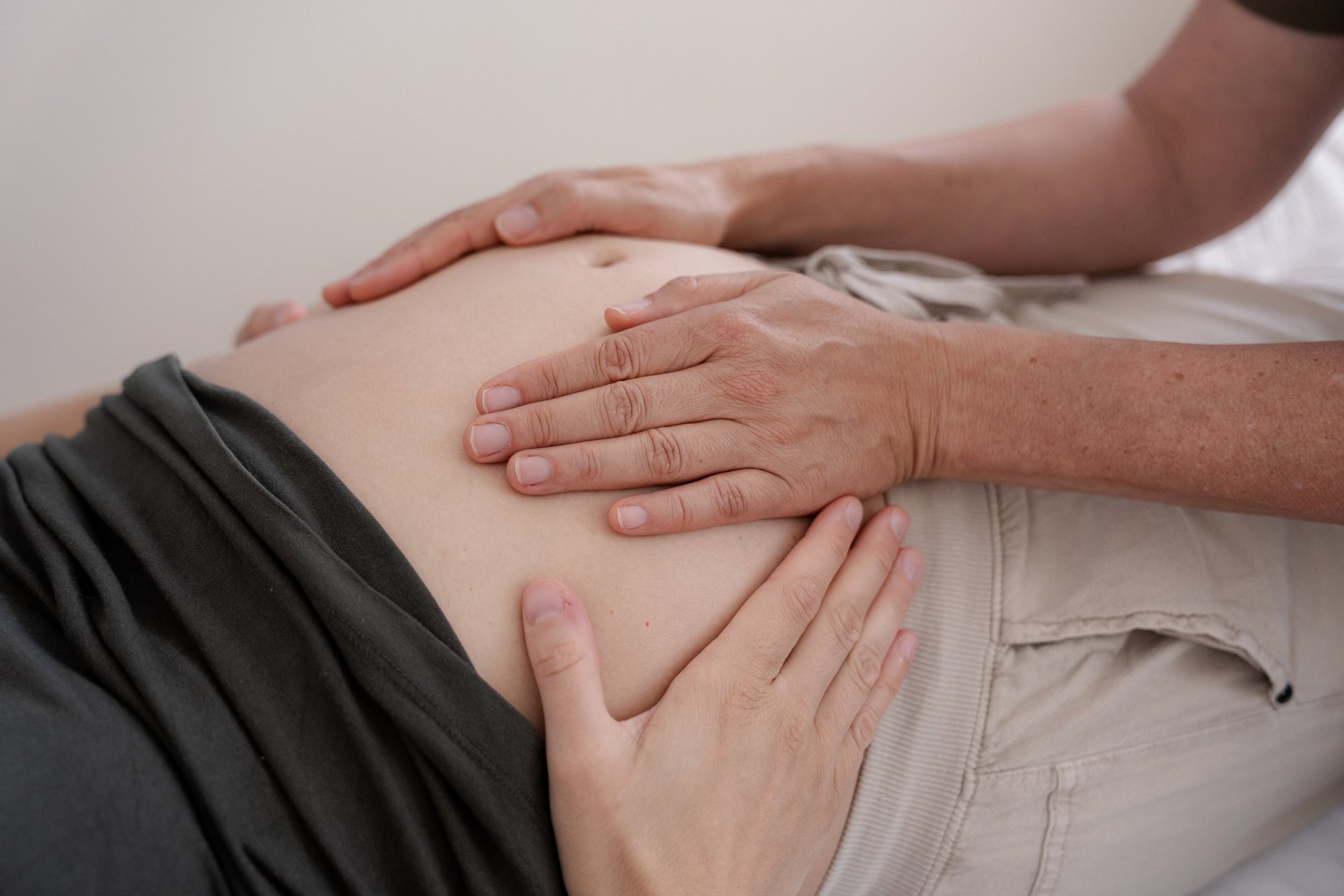 a pregnant woman holding her belly in her hands