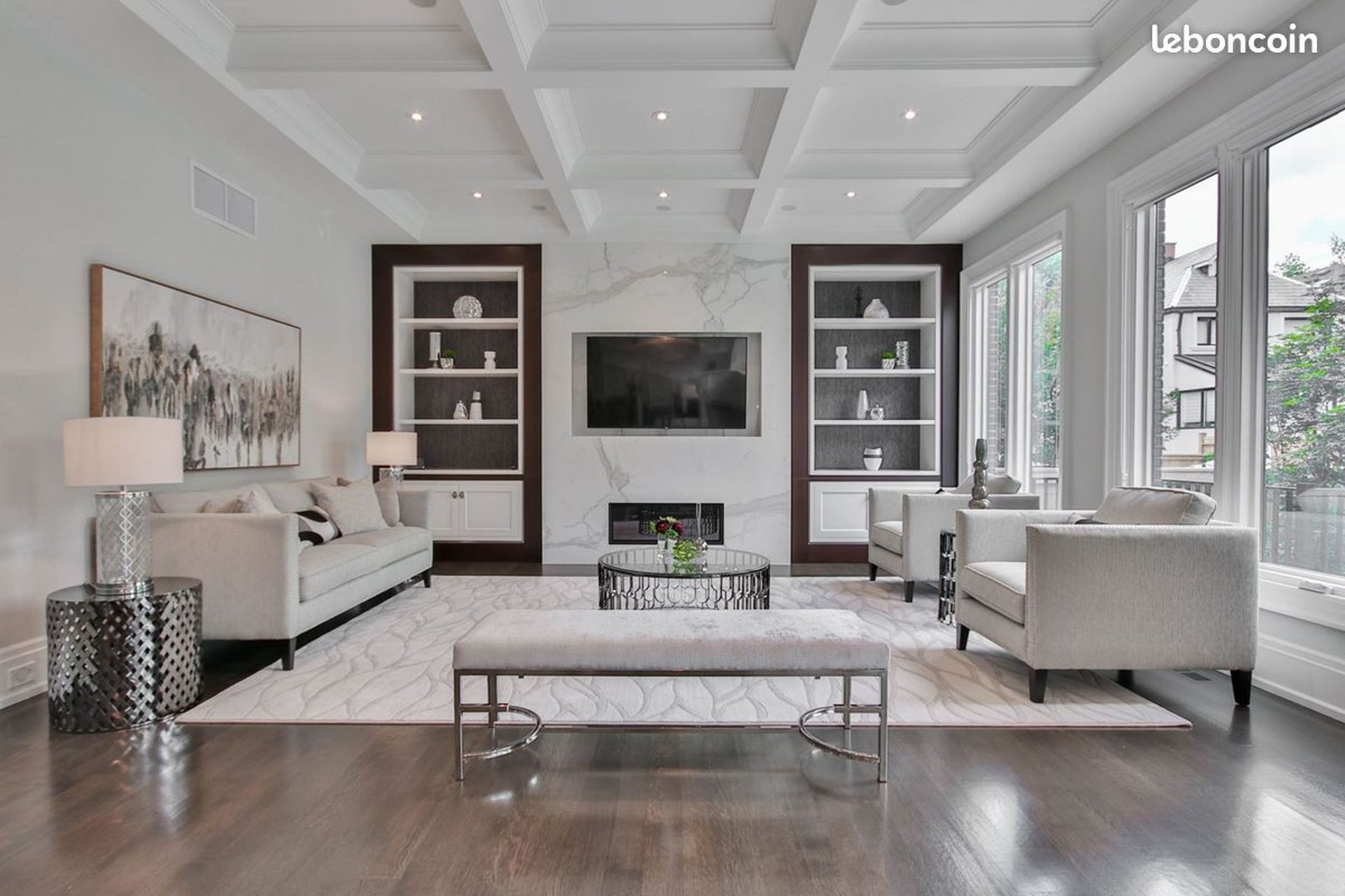 a living room filled with furniture and a book shelf