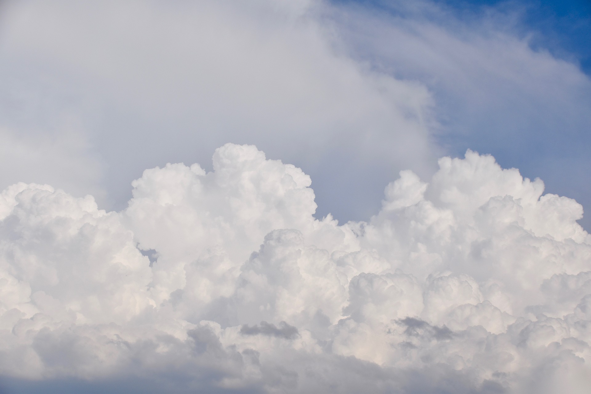 woman wearing yellow long-sleeved dress under white clouds and blue sky during daytime