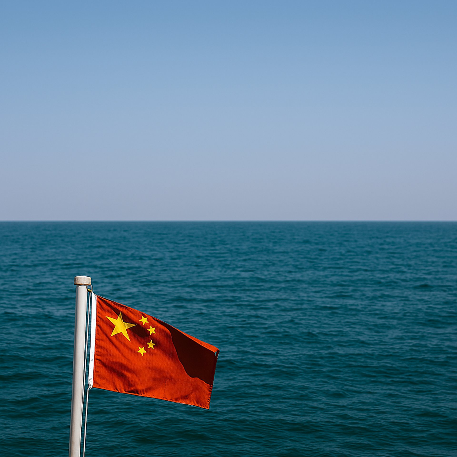 us a flag on flag pole near sea under cloudy sky during daytime