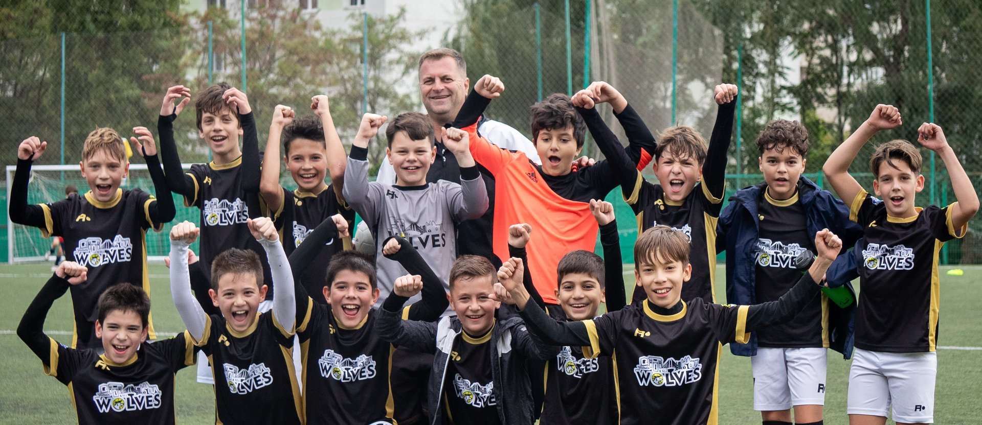man in blue crew neck t-shirt standing on track field during daytime