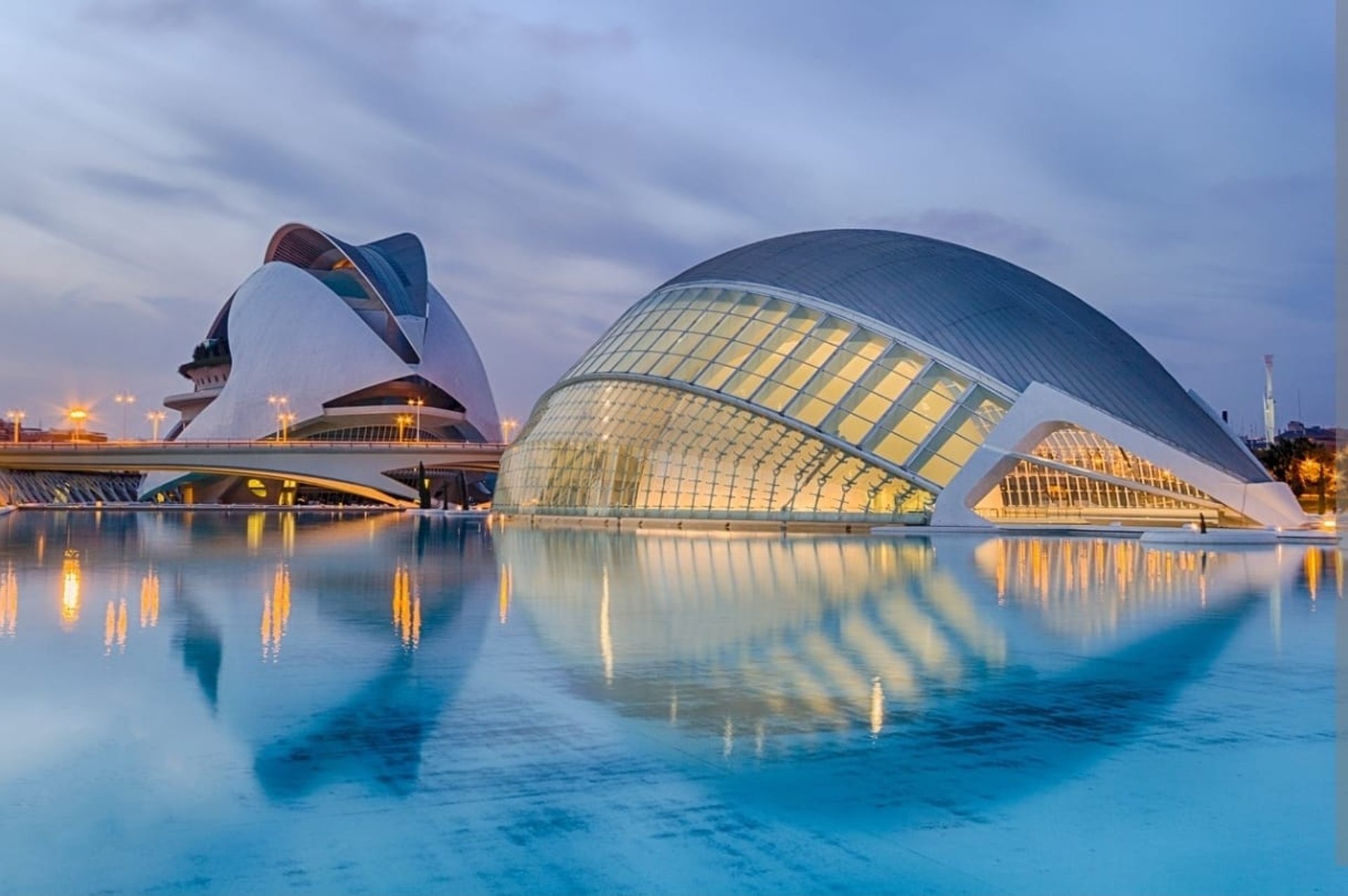 an abstract photo of a curved building with a blue sky in the background