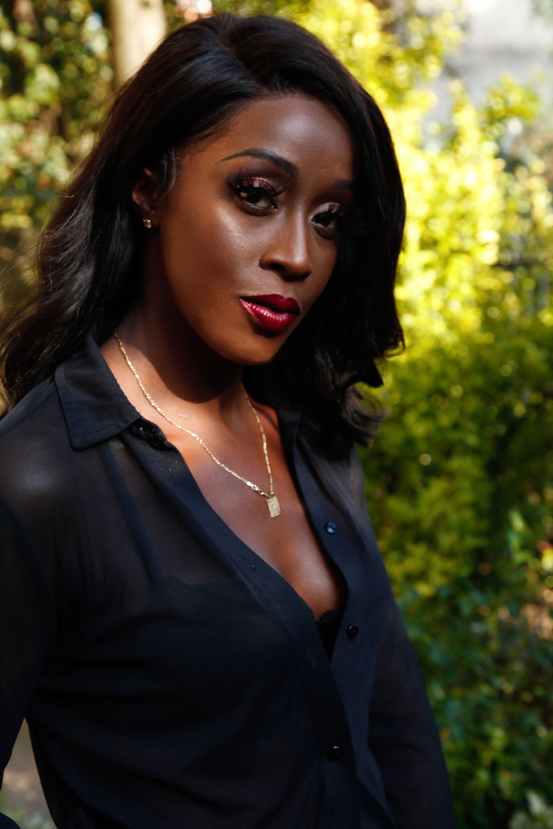 a woman with an afro is looking at the camera