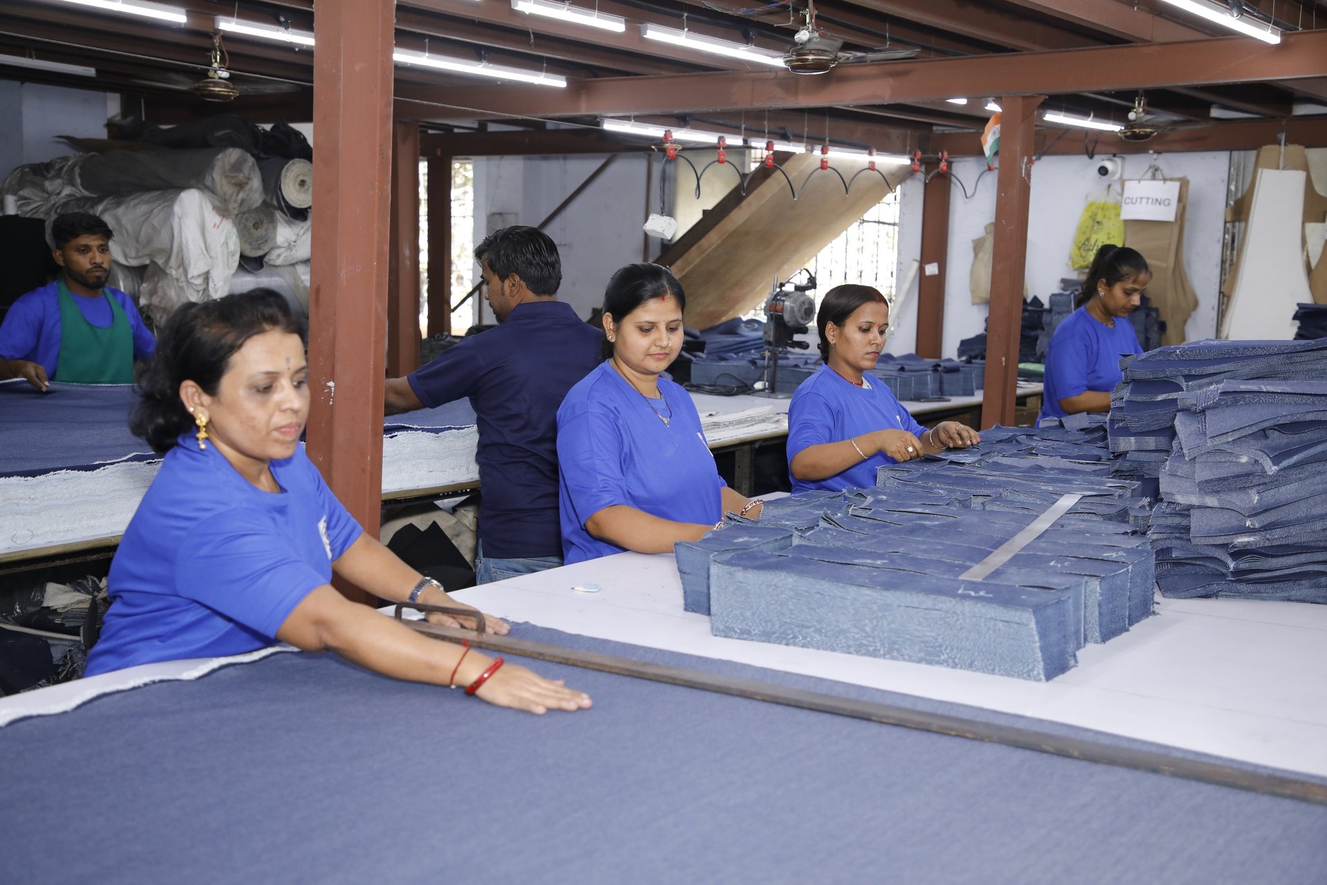 Workers are assembling textiles at a factory.
