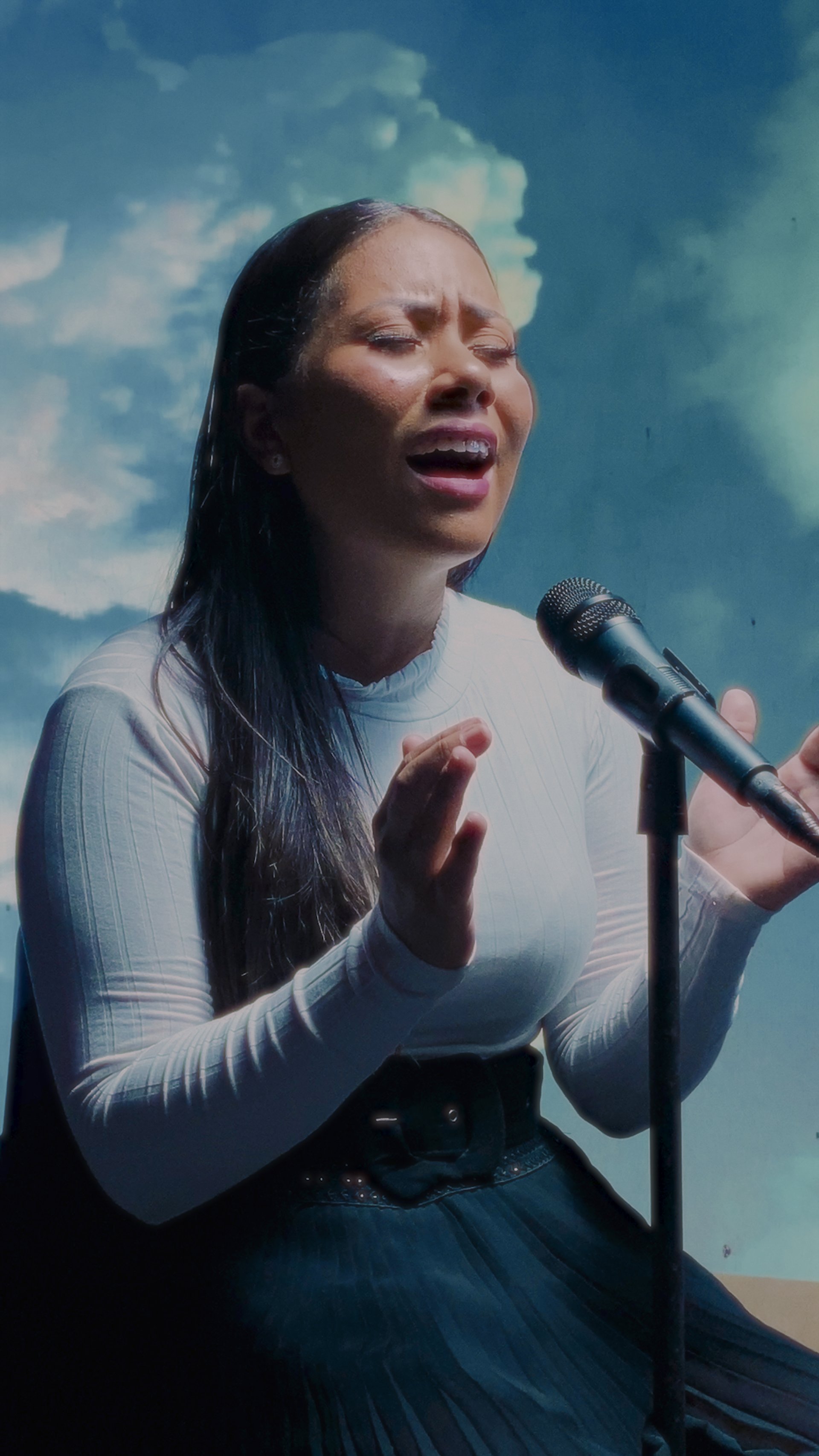 an abstract photo of a curved building with a blue sky in the background