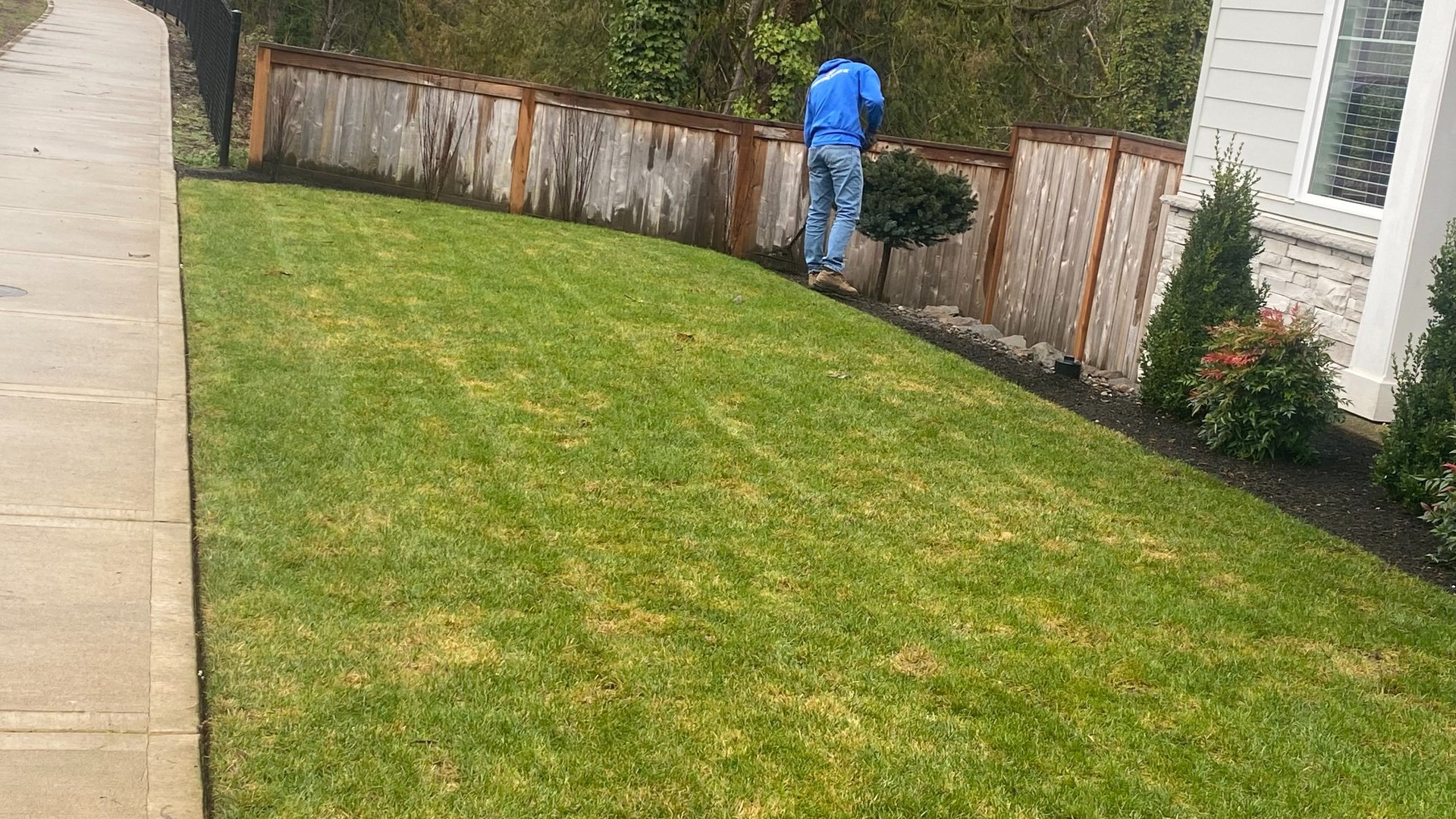 A man mowing a lawn with a lawn mower