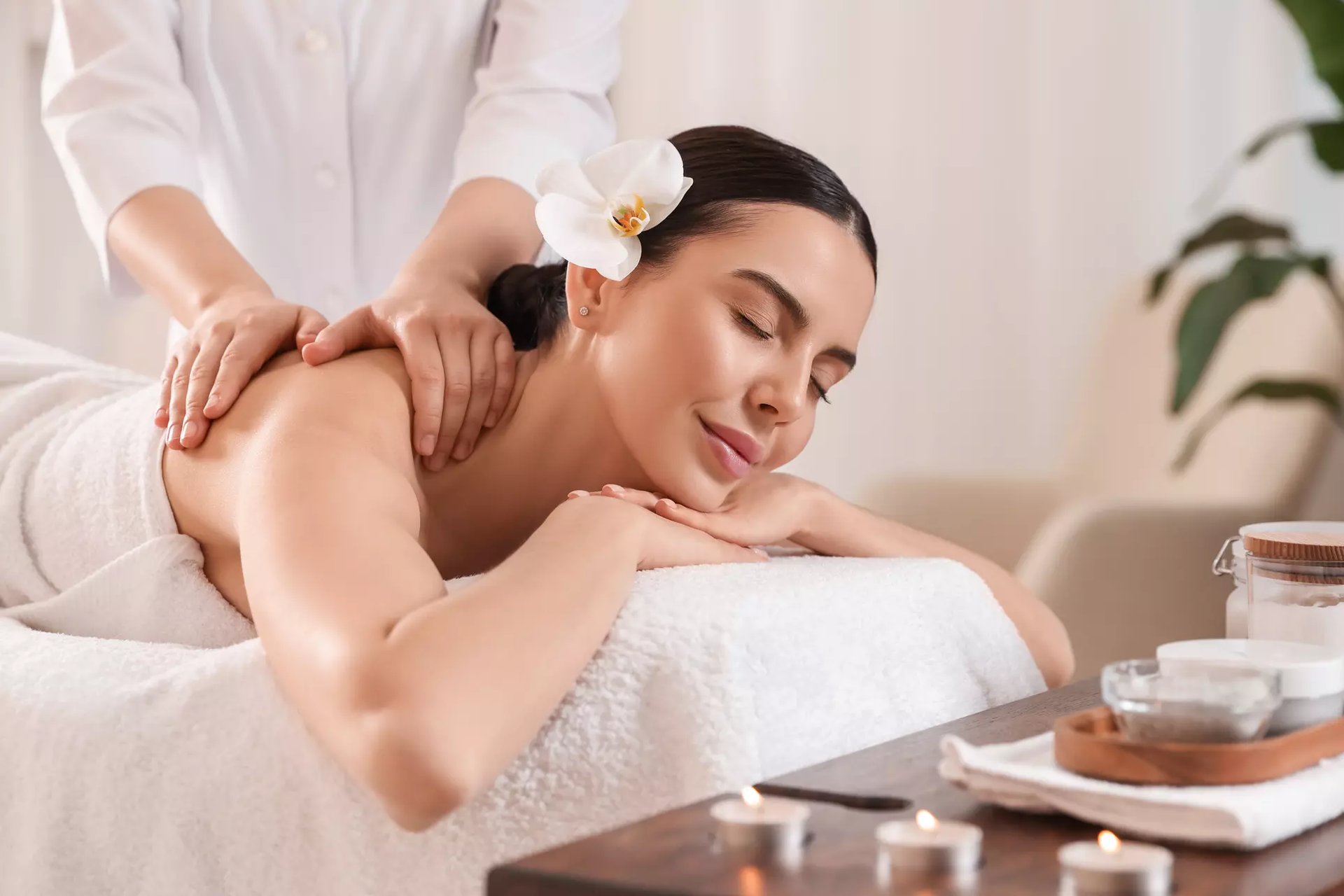 a woman getting a back massage at a spa