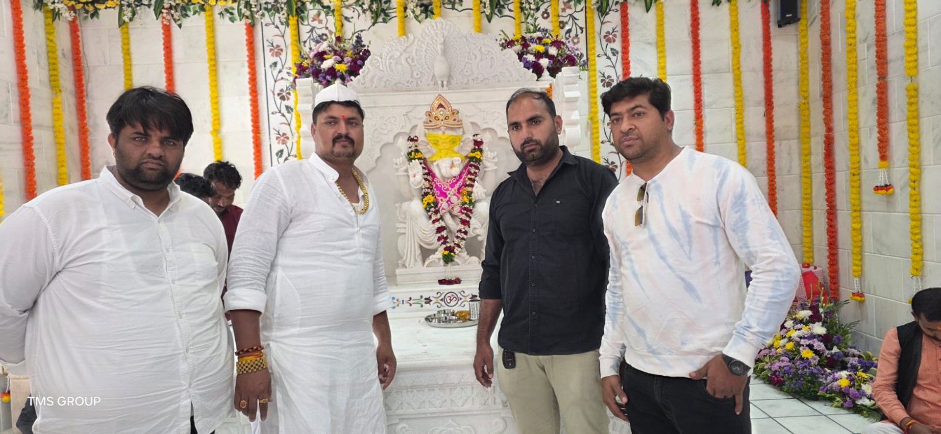 a group of people standing around a white building