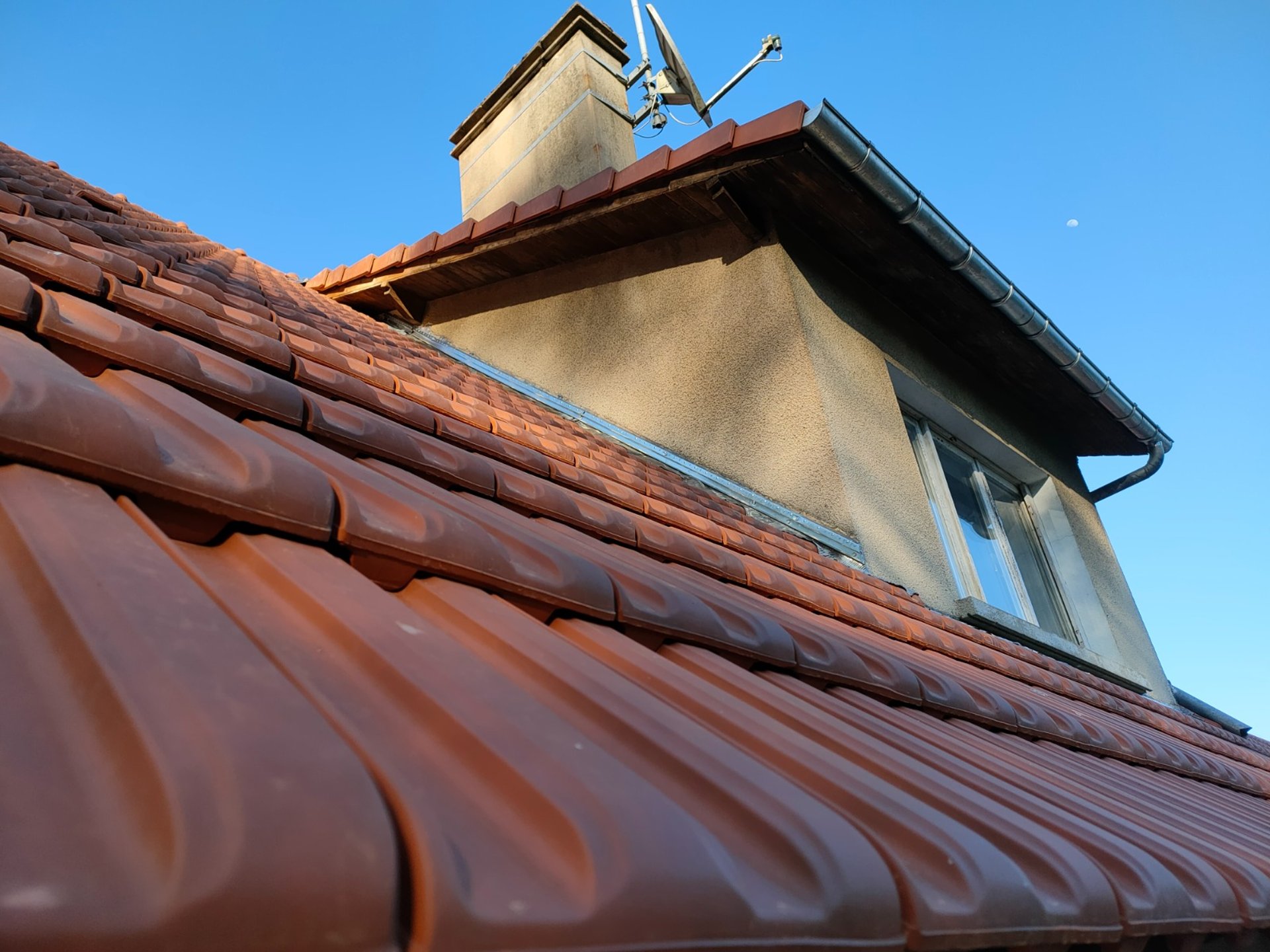 a man on a roof working with a rope