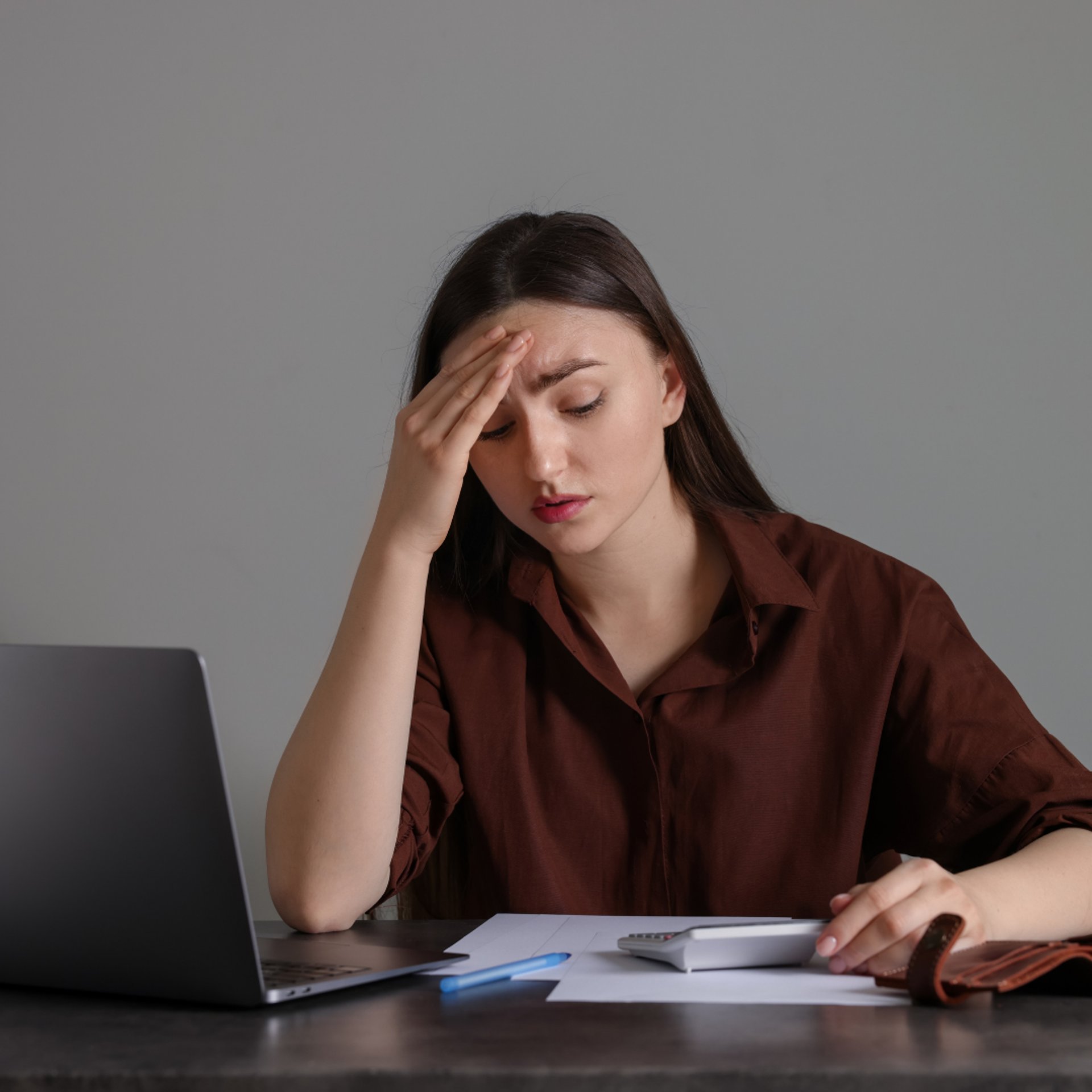 person holding brown leather bifold wallet