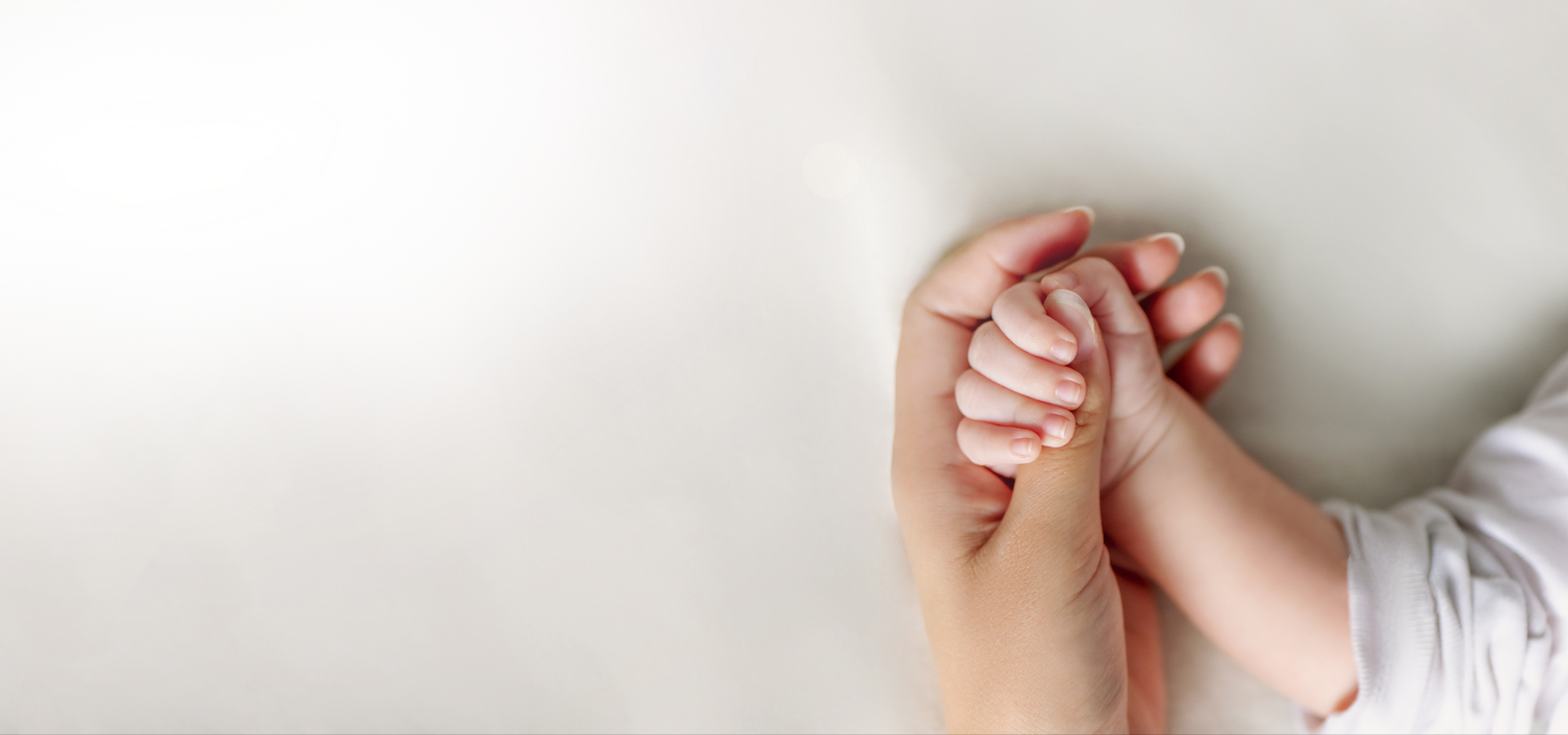 person holding baby's hand