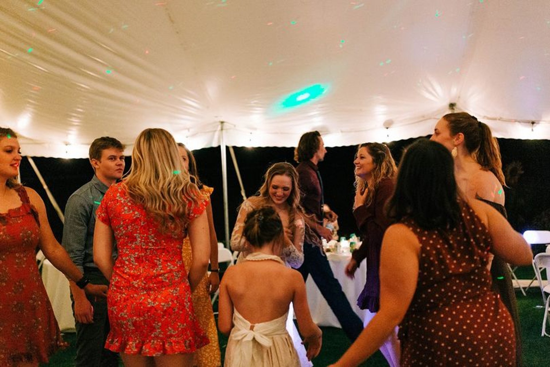 man in black suit jacket holding woman in white wedding dress