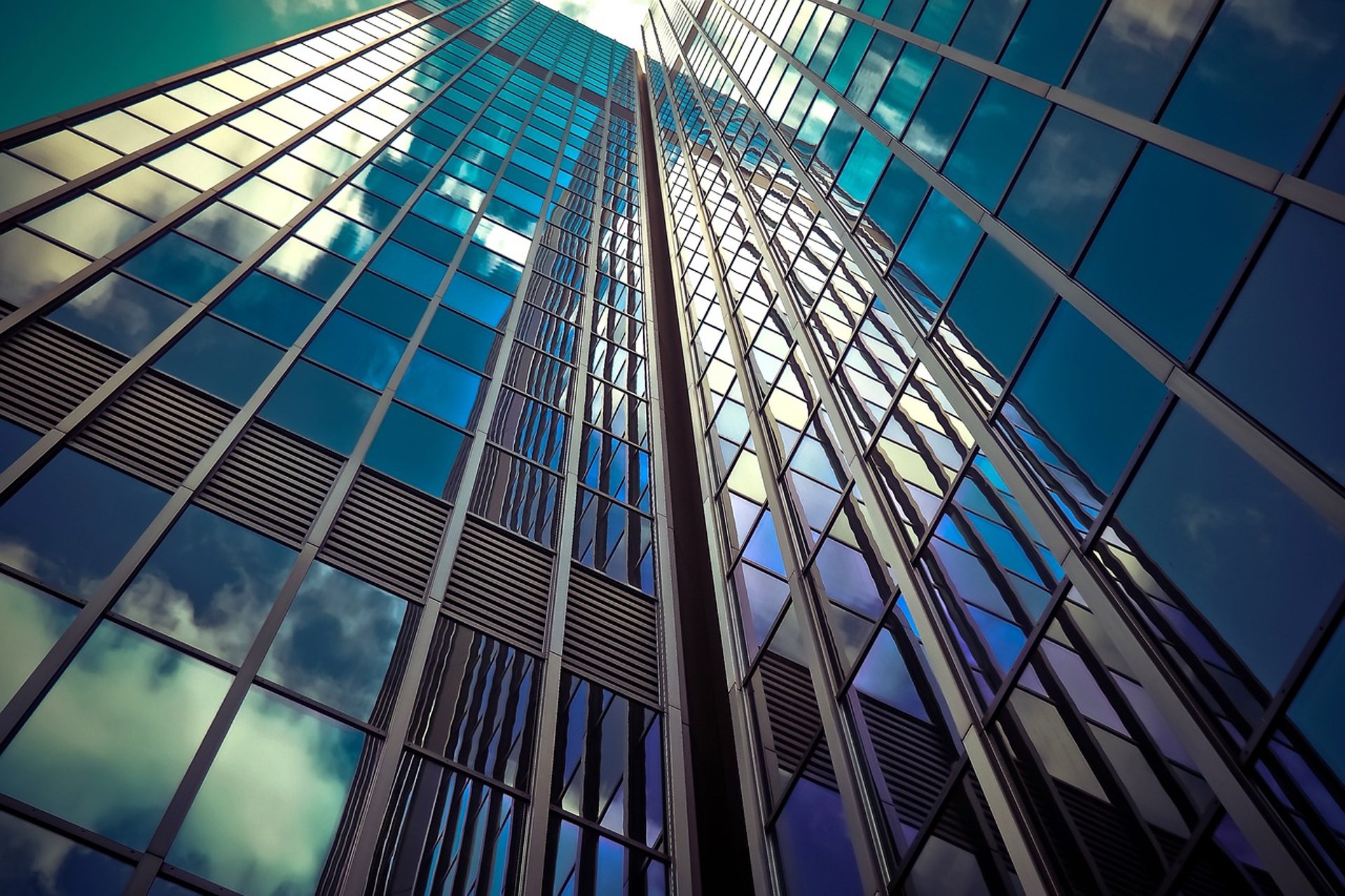 an abstract photo of a curved building with a blue sky in the background