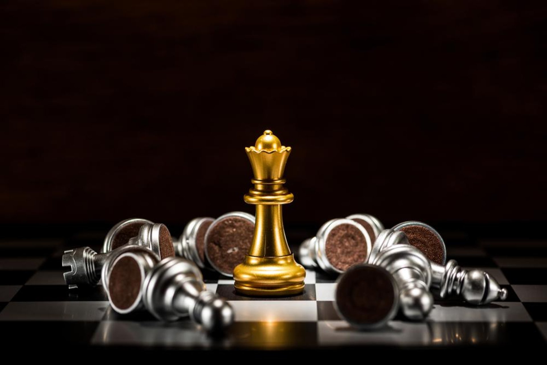 black chess piece on brown and white checkered table