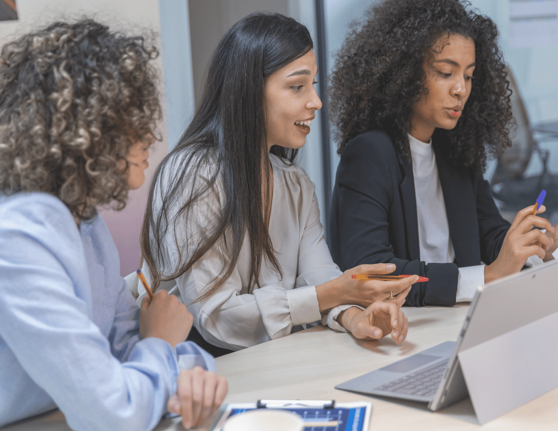 woman in black jacket sitting beside woman in white blazer