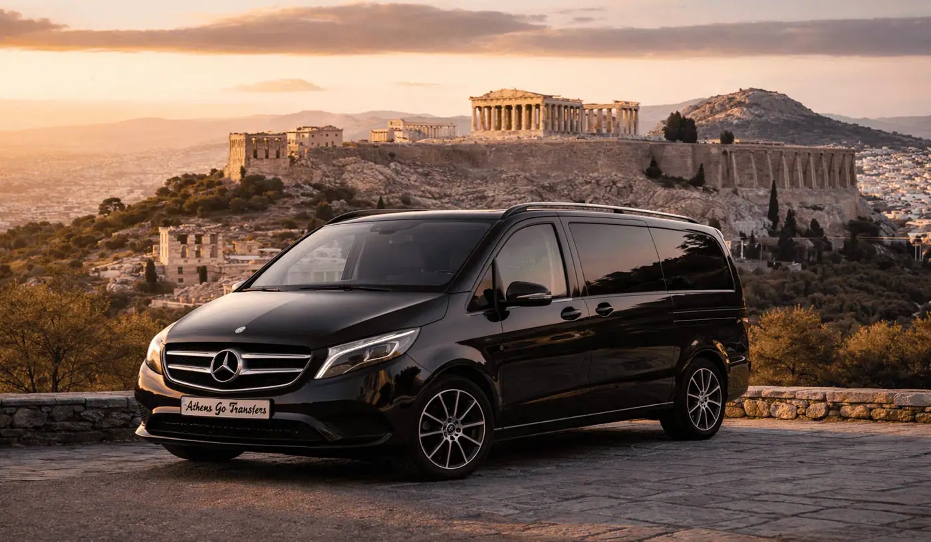 Luxury Mercedes-Benz Vito W447 by Athens Go Transfers parked at a scenic viewpoint overlooking the Acropolis in Athens Greece