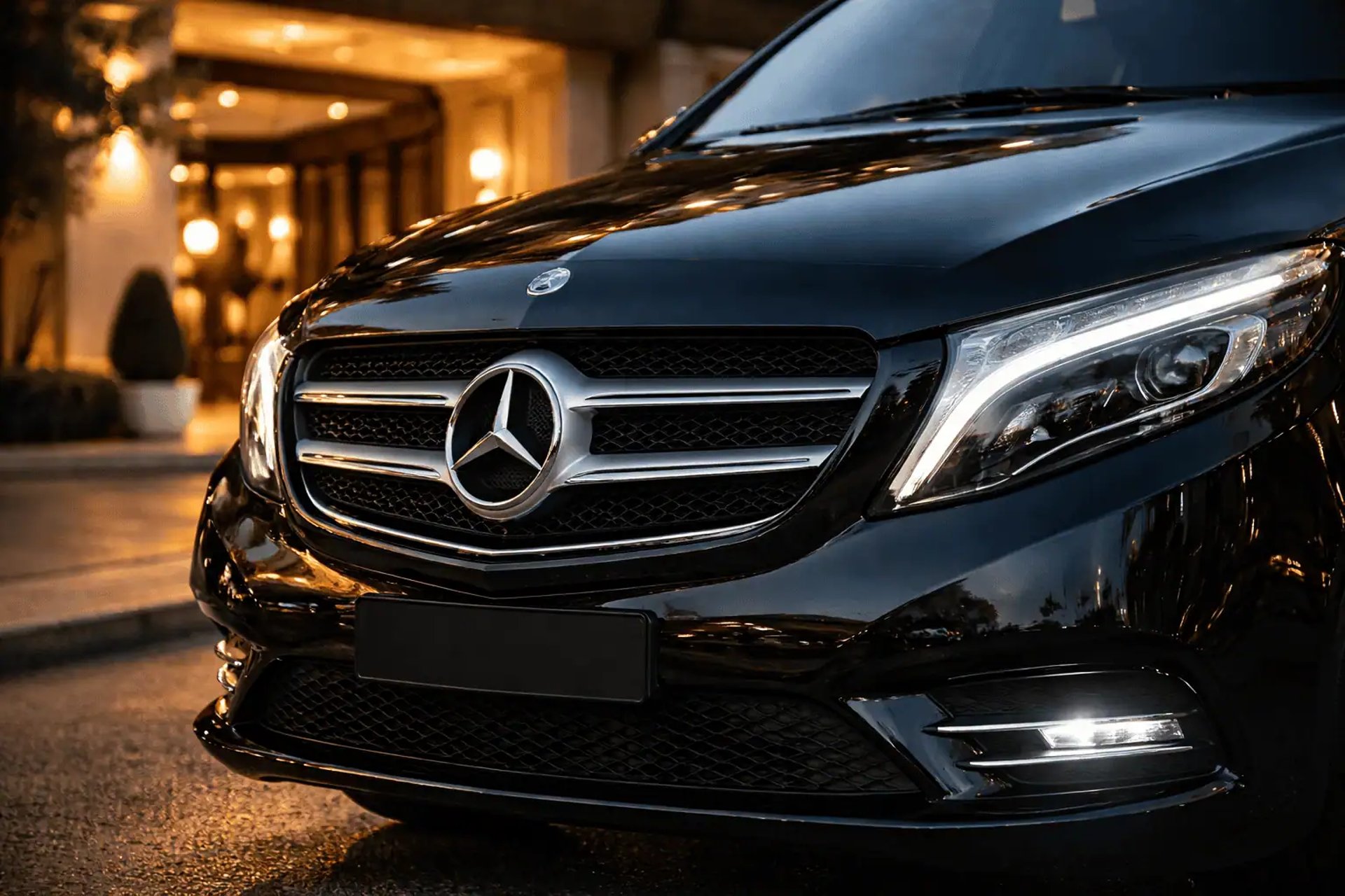 Front view of a premium black Mercedes-Benz Vito parked at a luxury hotel entrance in Athens