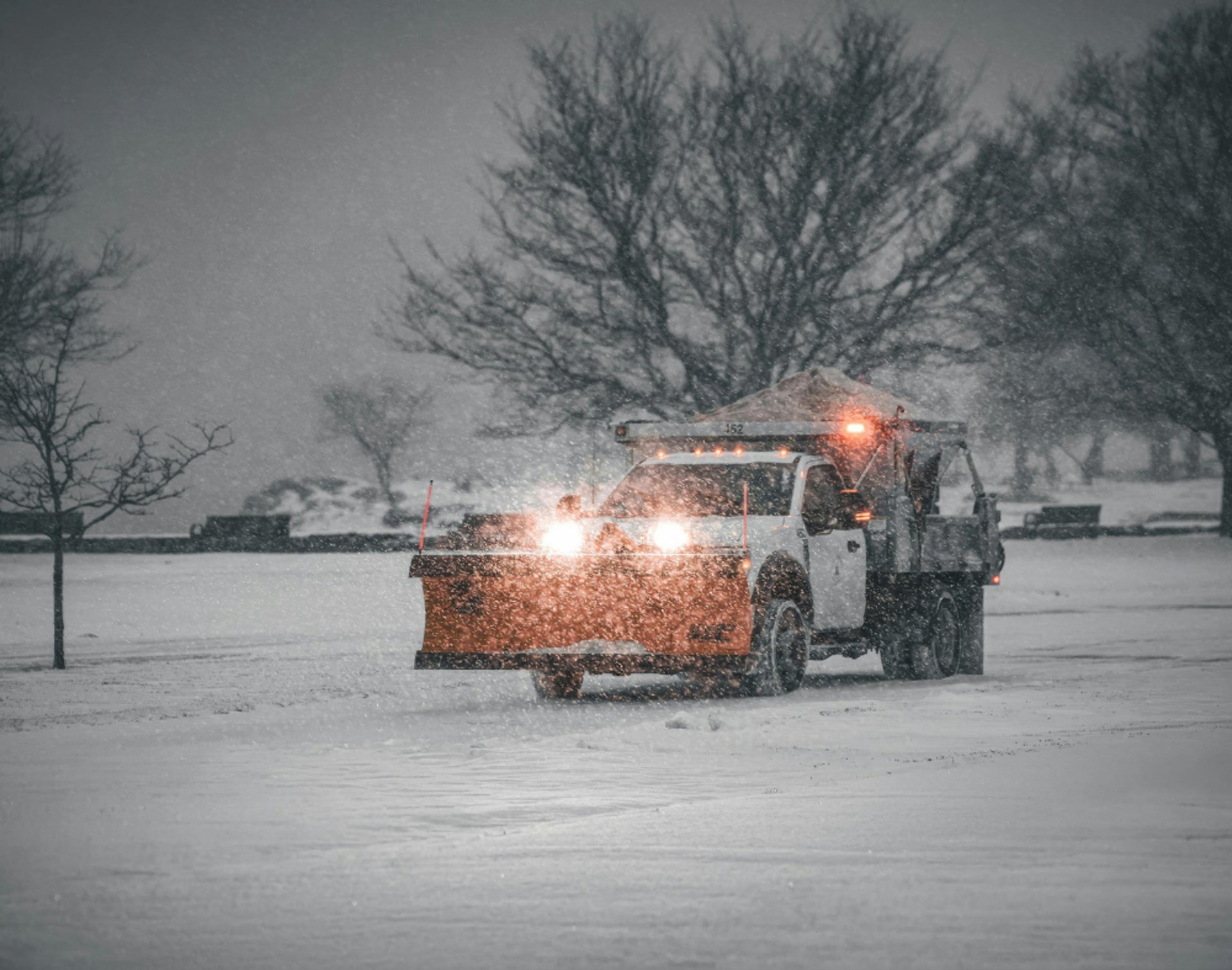 Ford truck plowing snow removal in commercial parking lot