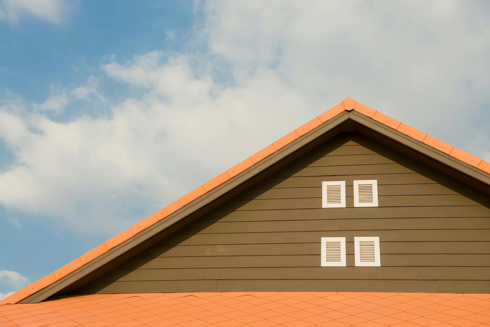 an orange roof and four windows