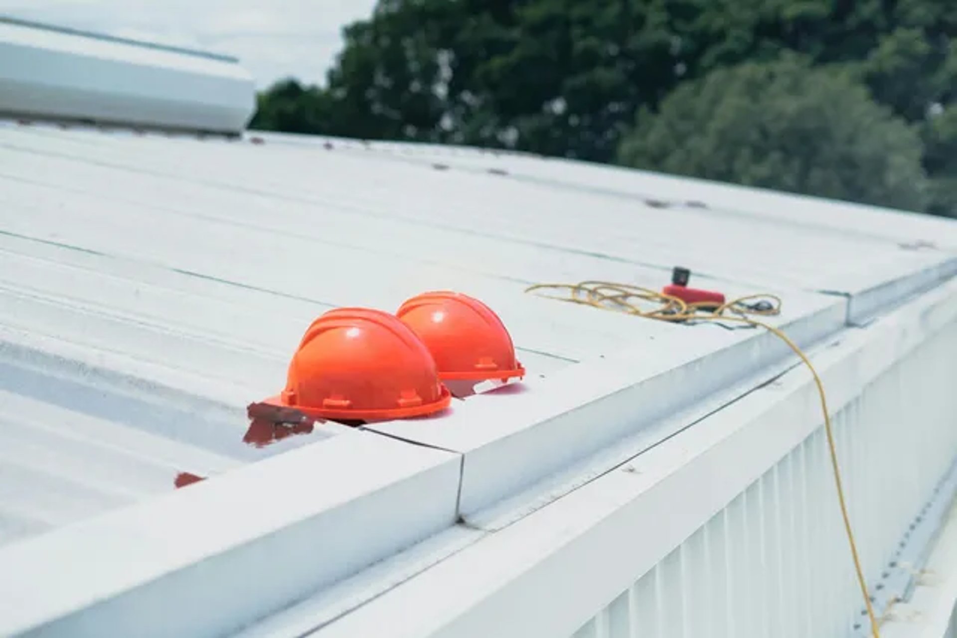 two orange helmet on top of the roof